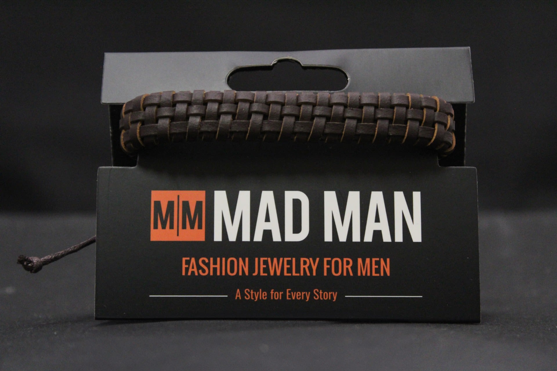 Men's Mad Man Leather Bracelet - Orlando - Chunky braided leather men's bracelet is a confident, casual gift for birthdays, Father's Day, or just-because moments. As a men's fashion accessory, this leather bracelet reads rugged and understated-the kind of piece that makes the person you're thinking of feel seen for his everyday style.  The band is a dark brown, woven leather with a textured, handcrafted look, finished with a black adjustable cord closure for a comfortable fit.   Perfect for dads, brothers, partners, or friends who favor simple, wearable accessories, this bracelet pairs well with denim and leather jackets and works as a low-fuss, thoughtful gift. Order with confidence for same-day pickup or delivery.