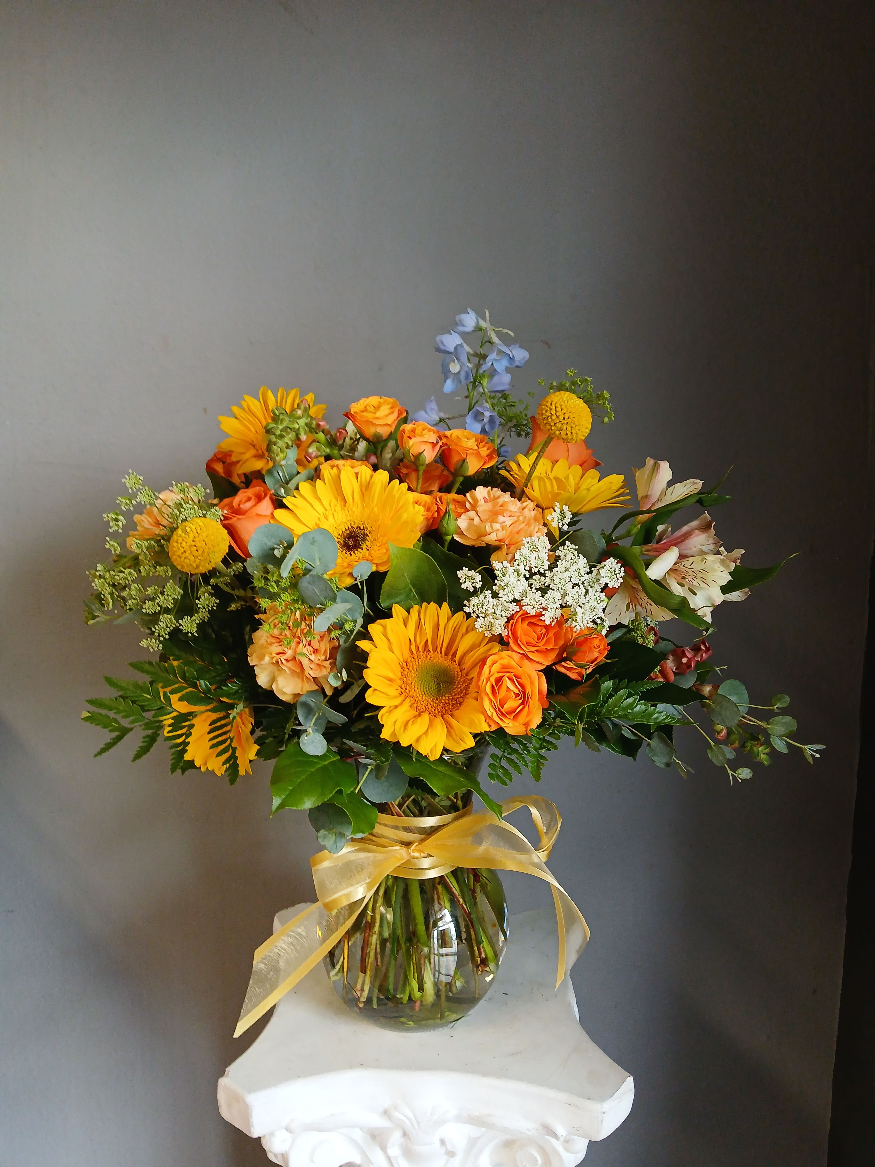 #719 Designer's Choice Seasonal Flower Arrangement - This beautiful flower arrangement of fresh mixed seasonal blooms is made by local designers in the heart Orange California. Hand crafted and perfect for every occasion, from birthdays and new babies to sympathy and just because. The best choice to show you are thinking of that special someone. Can be sent as a local delivery or in-store pickup. This is an original, one of a kind arrangement. Order now before it's too late!  UPGRADES: All upgrades are applied at the designer’s discretion and fulfilled to value using the freshest seasonal and/or premium flowers available. Container upgrades may be included when possible; otherwise, value is reflected in the floral selection while maintaining the original design style.