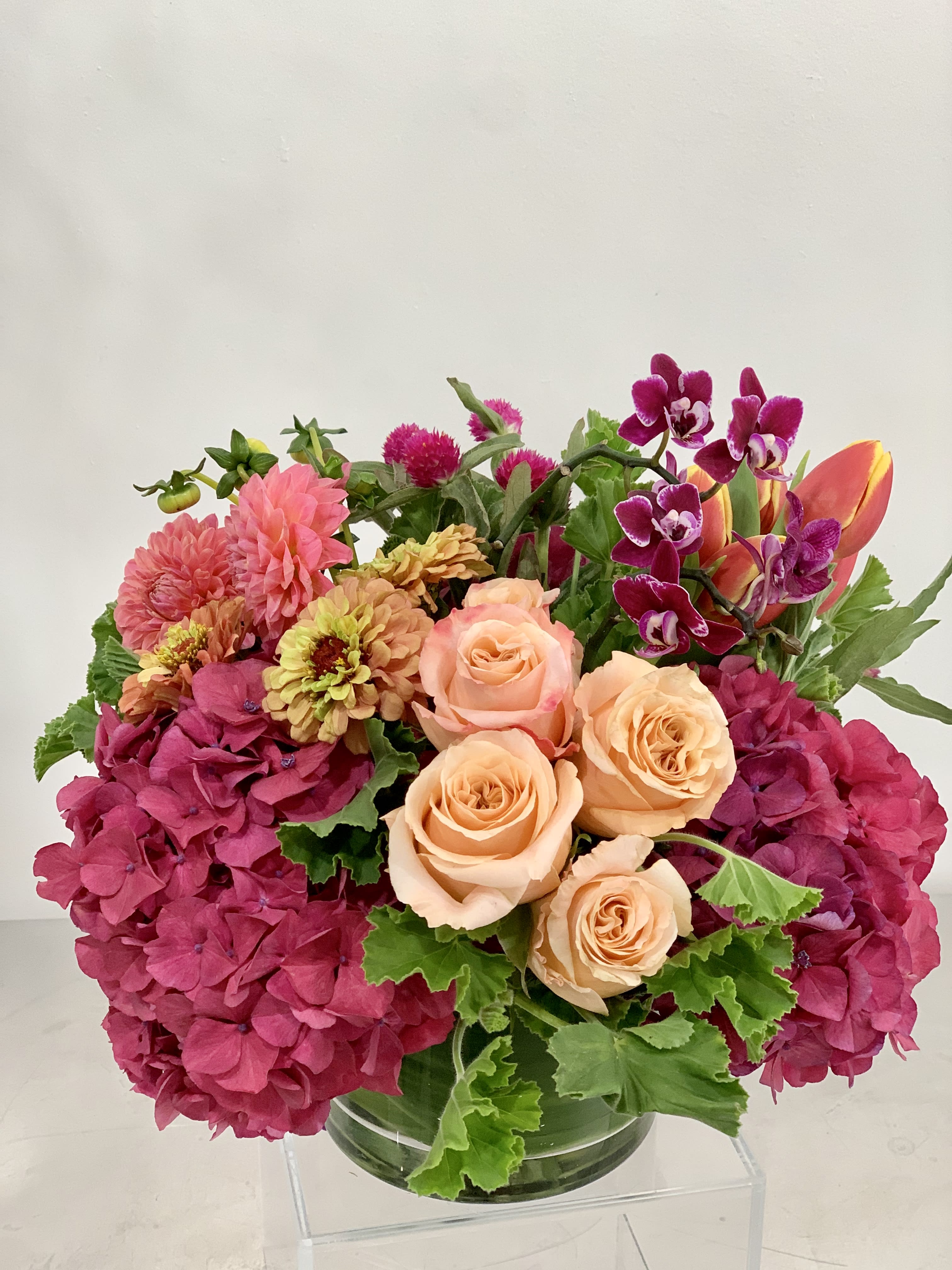 Summer of Love!  - Lush arrangement of summer colors: orchids, roses, zinnias, hydrangea, tulips, and more! Sure to brighten the spirits and to beautify the space of the lucky recipient. We will choose the best premium bouquets to use in this summer palette. This arrangement comes in three sizes:  Standard- suitable for a dinner table  Deluxe - more flowers and suitable for a large dinner table pr large coffee table Premium - premium blooms and suitable for an entry way, buffet, or large coffee table   If any design element such as color or vessel choice is very important to your order please contact us to ensure availability first. 415 751 2747 or info @ fleurtstyle . com 
