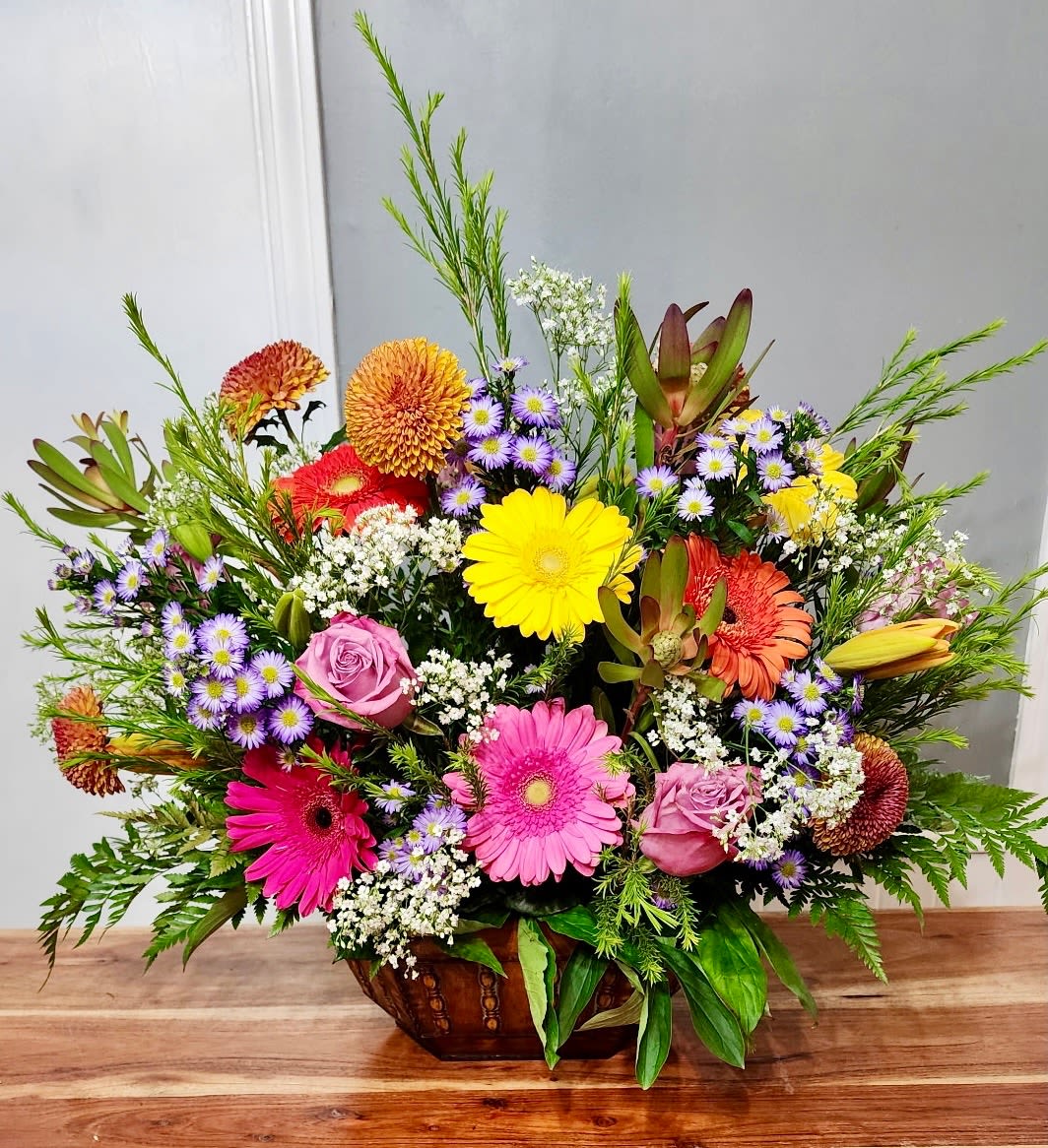 Gerbera Garden - An amazing kaleidoscope of mixed blooms with Gerbera Daisies front and center set in a beautiful backdrop of lush greenery.