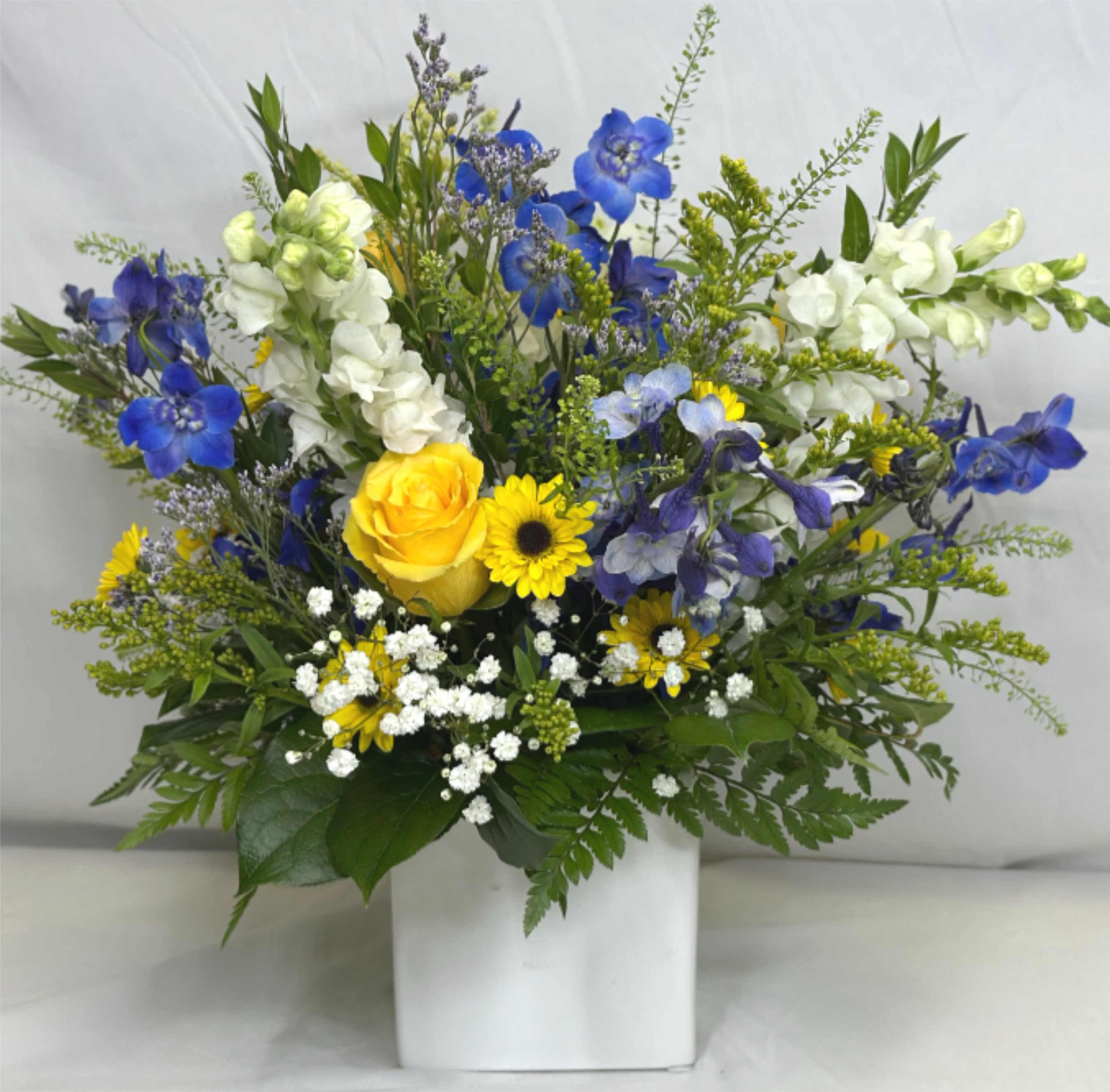 Blue Skies and Sunshine - There is nothing like a bright sunny day with clear skies. This Leary's Flowers exclusive design brings that cheerful sunshine right to you. This is a perfect all around arrangement and would be a great gift for saying thank you, a new baby, or any occasion where you want to brighten someone's day. If the featured flowers are unavailable we will design your arrangement using the freshest available blooms of equal or greater value.