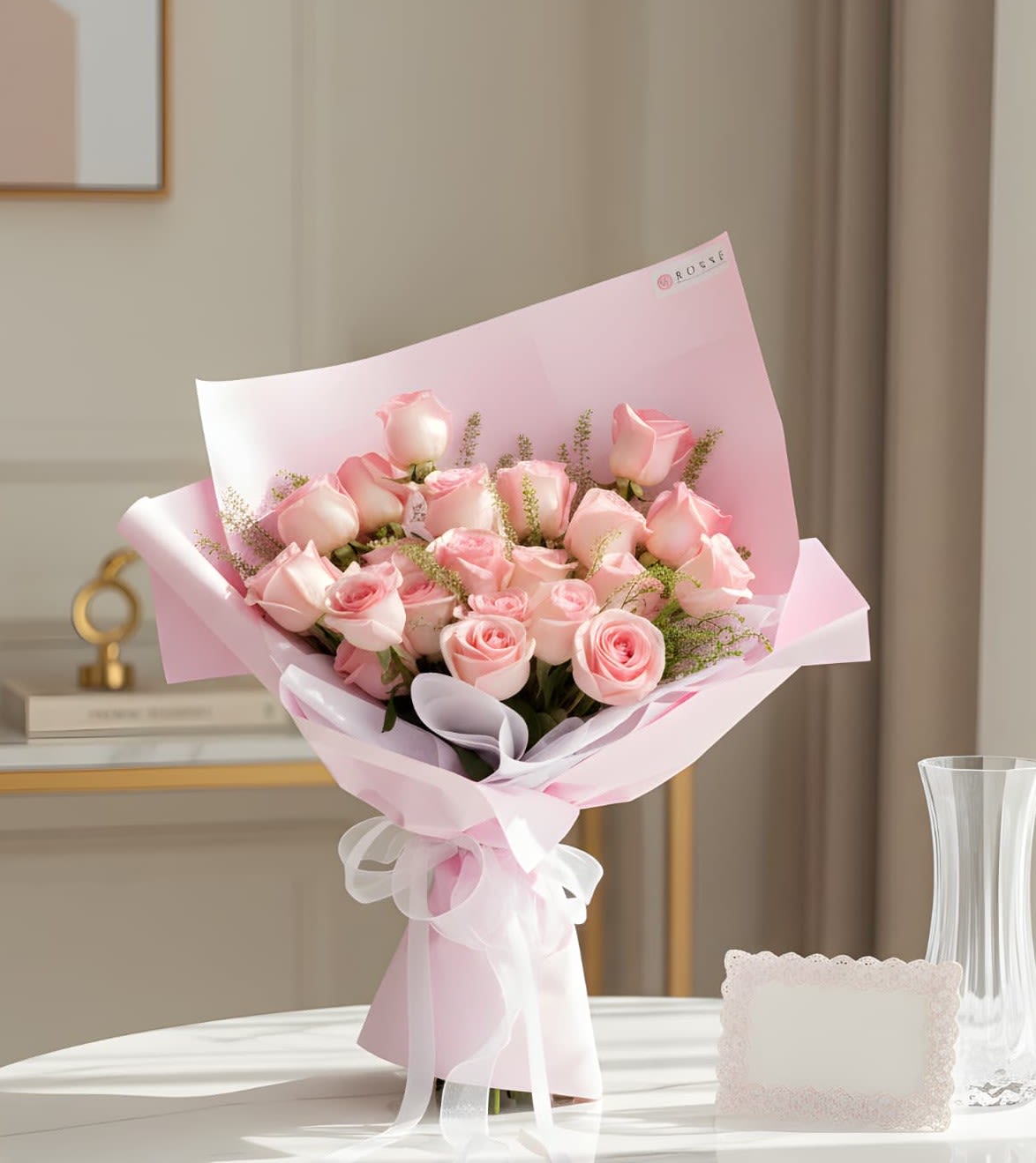 Bouquet of pale pink roses wrapped in pink paper with a white ribbon