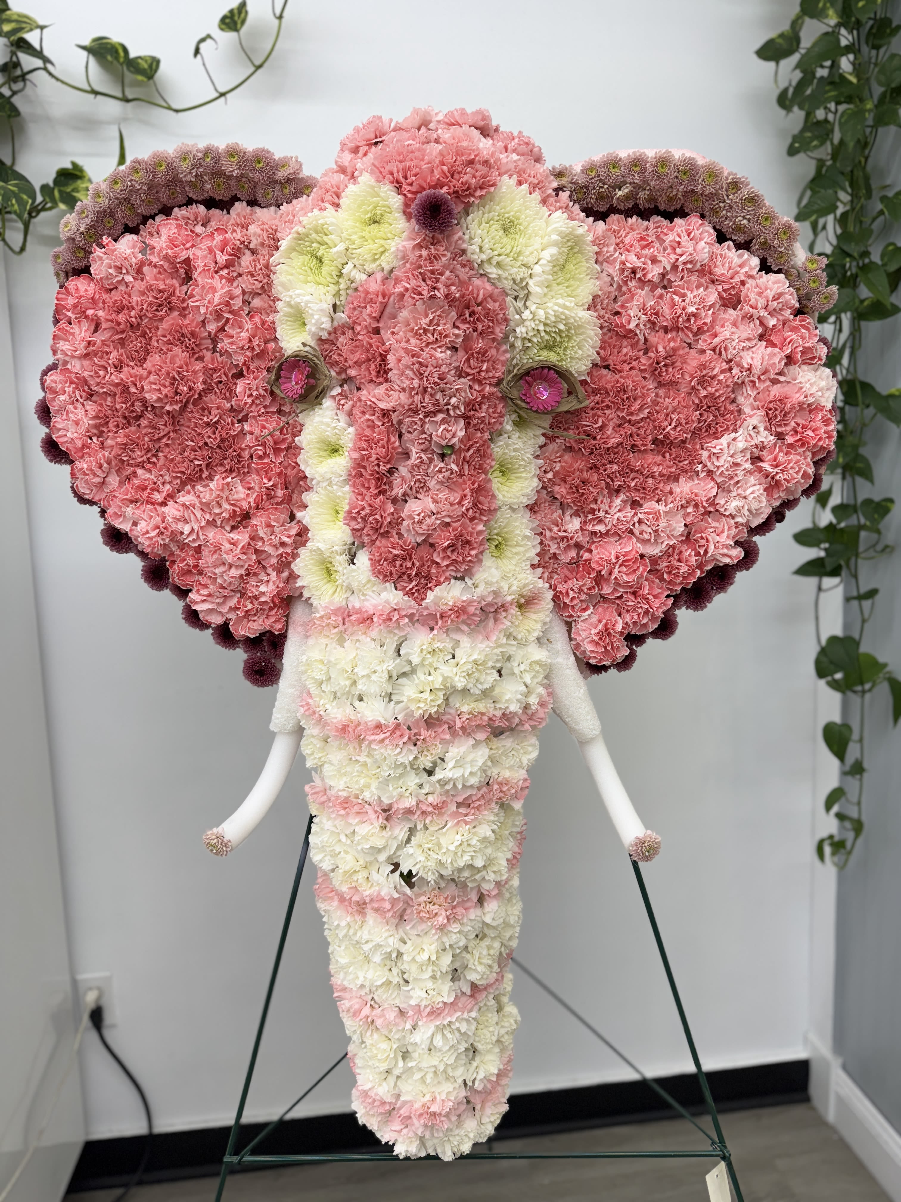 Elephant-shaped floral arrangement in pink and white carnations