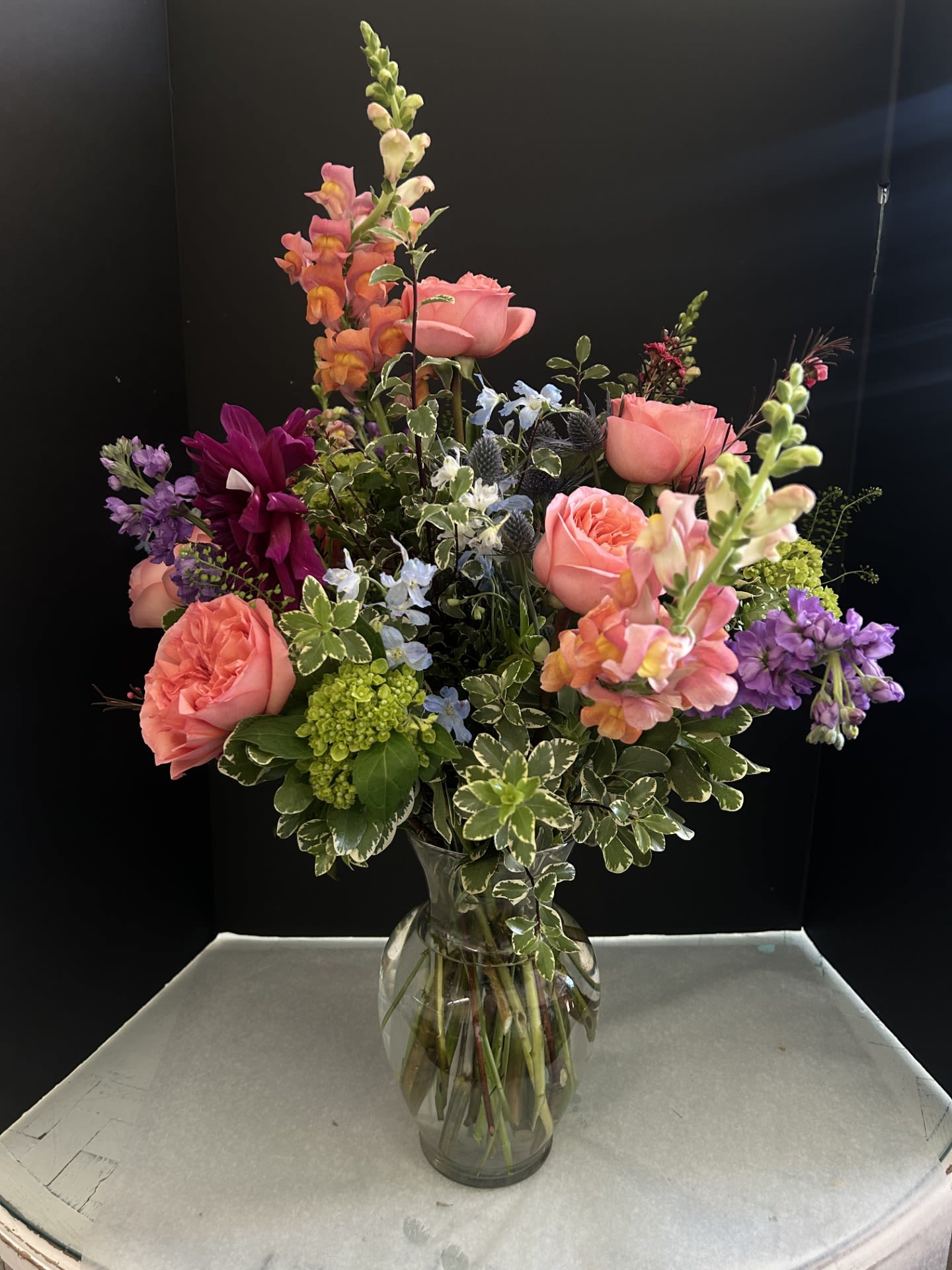 Wild Summer Meadow - Beautiful  Summer Arrangment  with orange snaps, Peach garden roses , blue delphinium, purple Dahlias , purple Stock, waxflower, thistle and mixed wild greens .