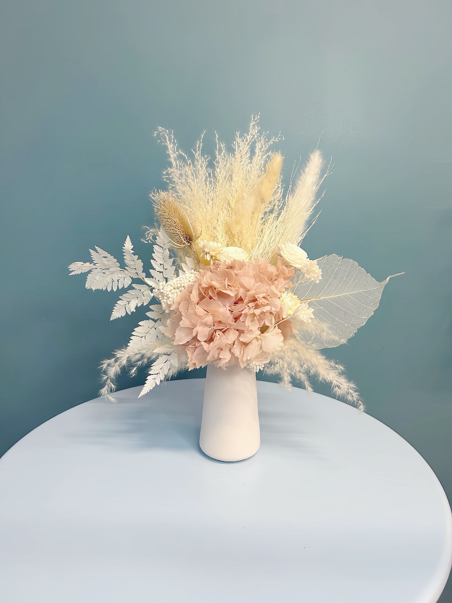 Blush dried flower arrangement in a white vase