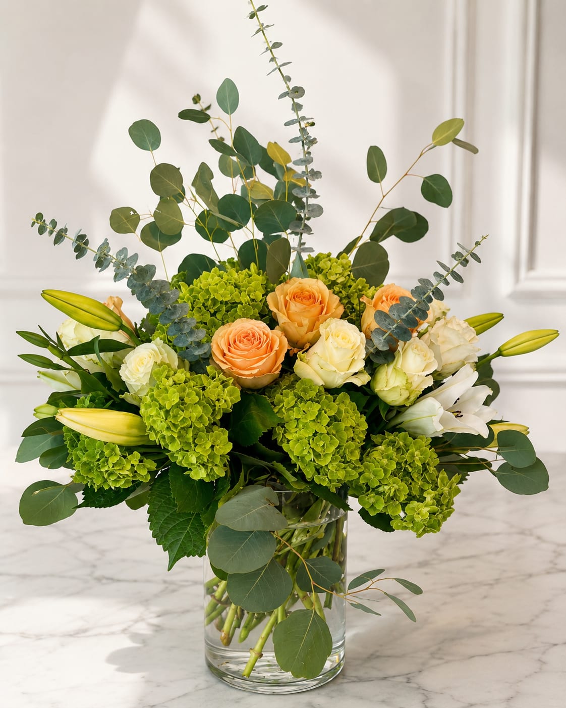 Elegant Harmony  - Experience the perfect blend of elegance and charm with our “Elegant Harmony” bouquet. Soft peach roses meet pristine white roses, complemented by majestic white lilies and lush greenery, creating a stunning visual symphony. Each bloom is carefully arranged to radiate beauty, grace, and sophistication—an unforgettable gift for someone special or a luxurious treat for your