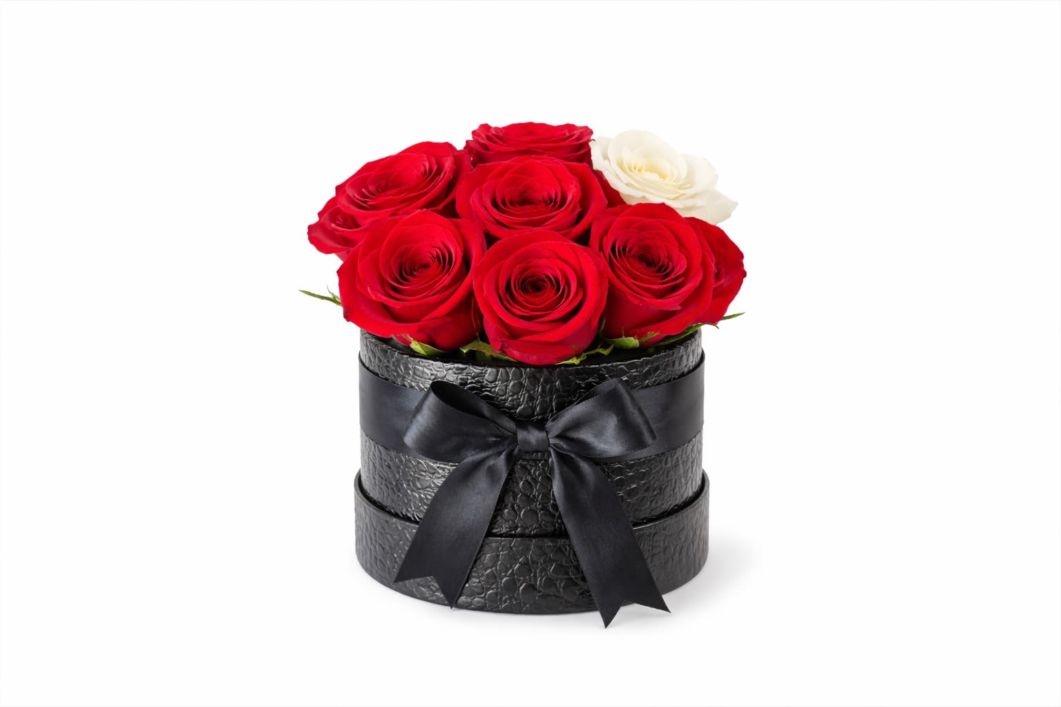 Red and white roses arranged in a black round box with a ribbon