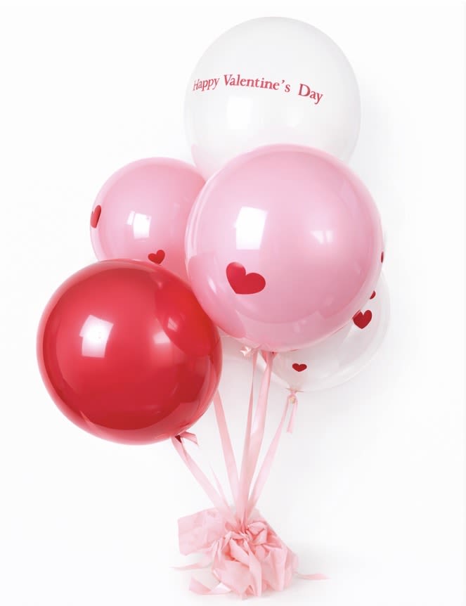 Cluster of pink, red, and white heart balloons with a Valentine’s Day message