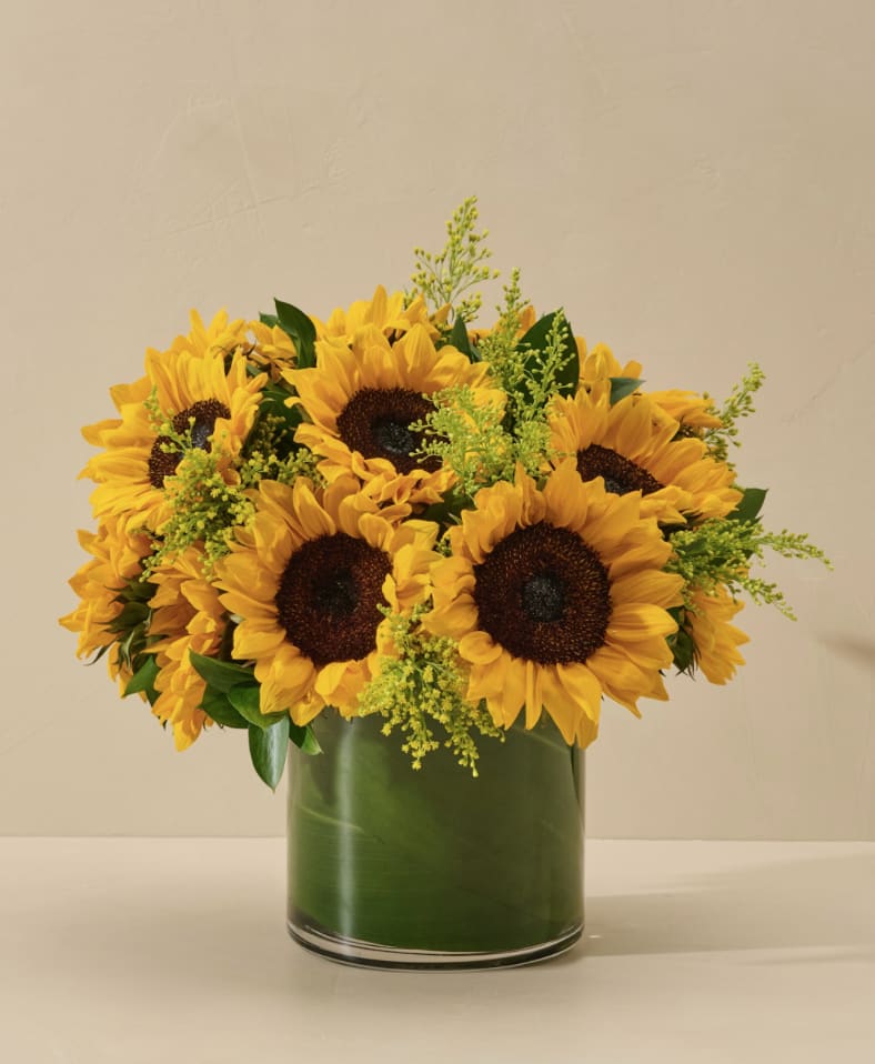 Sunflower bouquet in a green glass vase