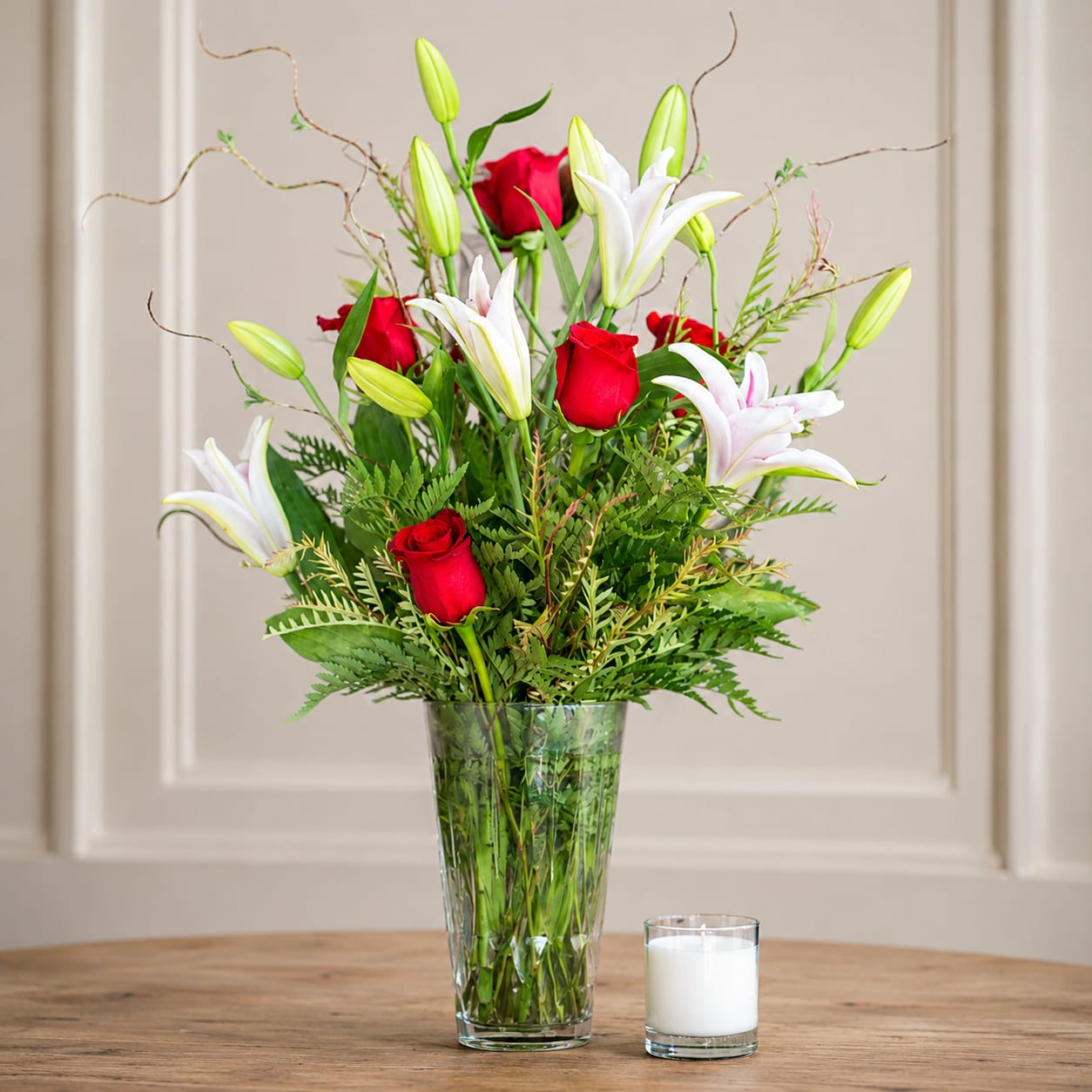 Lilies in Love - Stargazer lilies fall in love with bright red roses, accented with seasonal greens and willow. This product may require a 24 hour notice because of the lilies. (All designs are arranged as similar as possible. We promise to keep the same color, style, and overall theme with what Mother Nature generously blesses us with, Lilies may be buds on arrival)