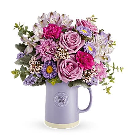 Lavender and pink bouquet in a purple pitcher vase