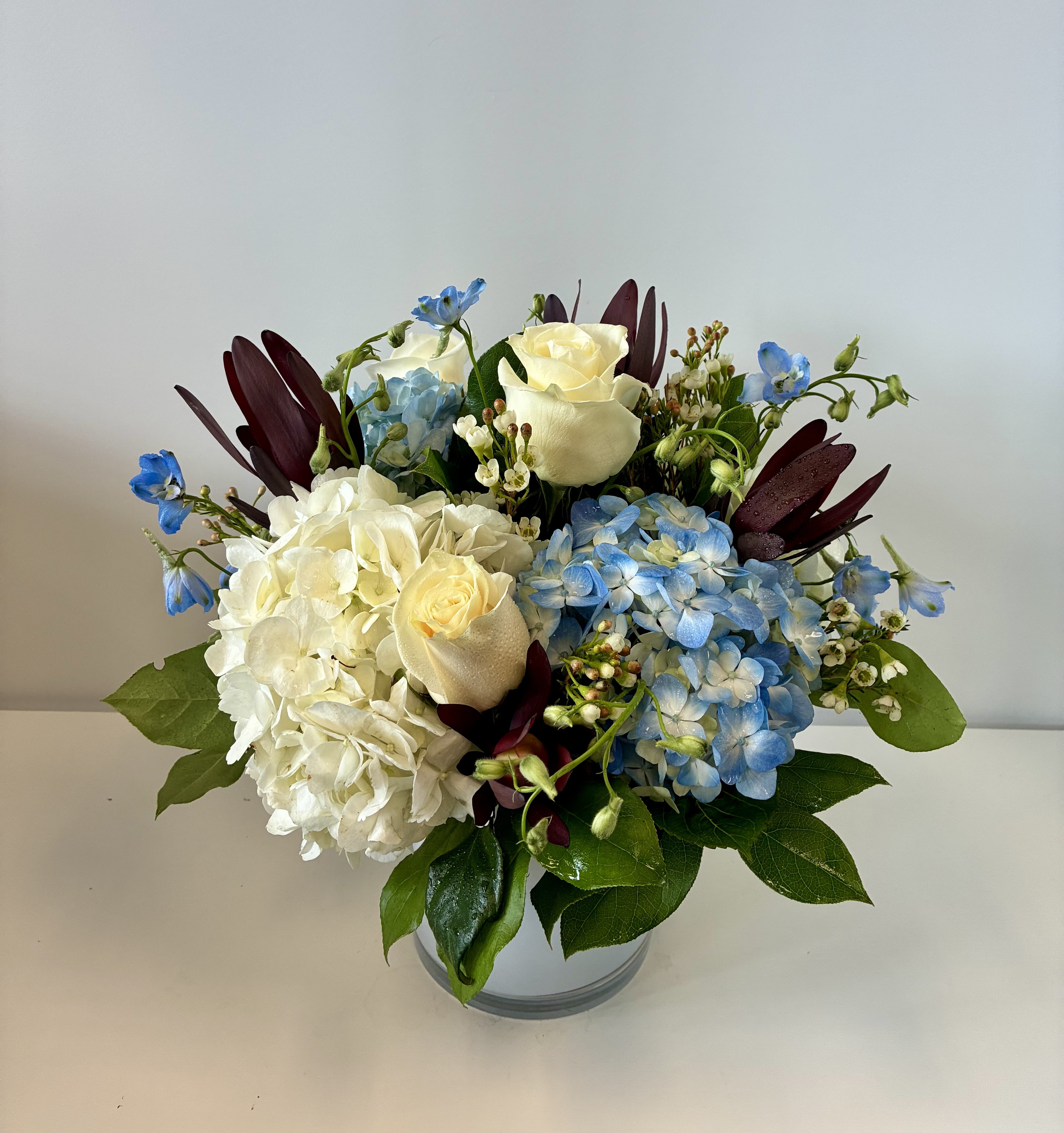 Patriotic Petals - Cool, elegant clusters of white and blue hydrangeas set the tone for this patriotic bouquet, making Patriotic Petals.