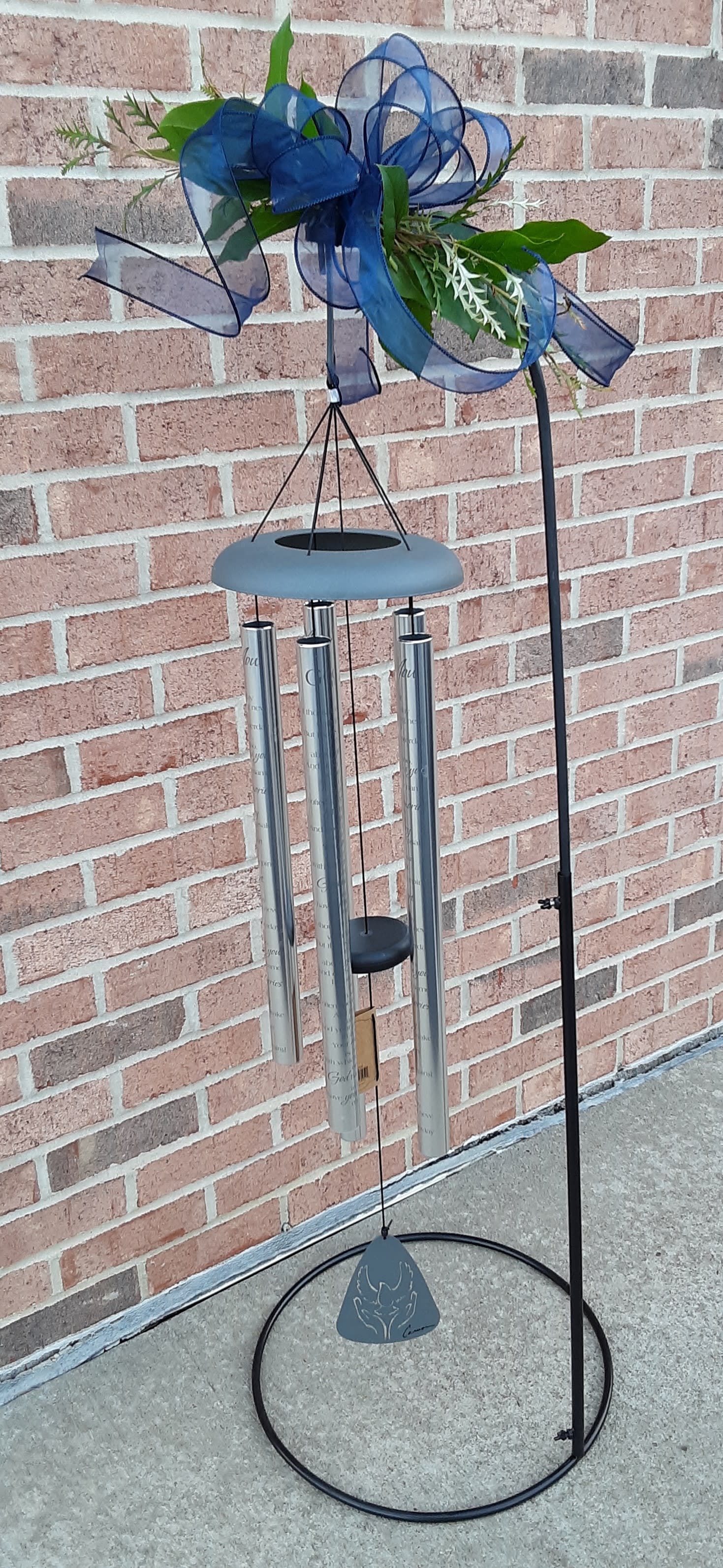 Blue ribbon wind chime with a small floral accent