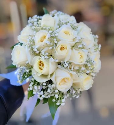 White rose bridal bouquet with baby's breath and ribbon