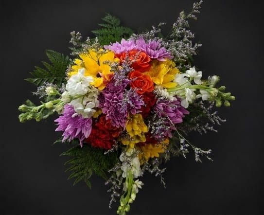 Summer Blooms Bouquet - A lush, rounded celebration of color, this flower arrangement is a joyful summer bouquet perfect for birthdays, congratulations, or just because. The mixed-color Summer Blooms Bouquet brings together roses and large chrysanthemum-like blooms with stock and airy white filler to create an energetic, festive display that reads as both cheerful and sophisticated-ideal when you want the person you're thinking of to feel noticed and celebrated.  