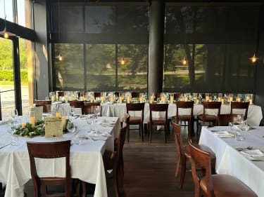 Wedding reception tables with white linens and small floral centerpieces