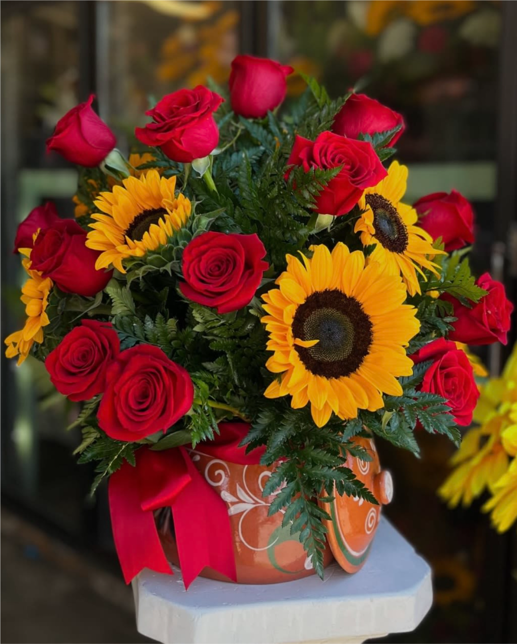 "Ollita" Sunflower And Red Rose Design - 20 red roses with sunflowers all arranged in a terracotta pot, perfect for a thoughtful Spanish gift. The pot is able to be used afterward as a cooking pot.