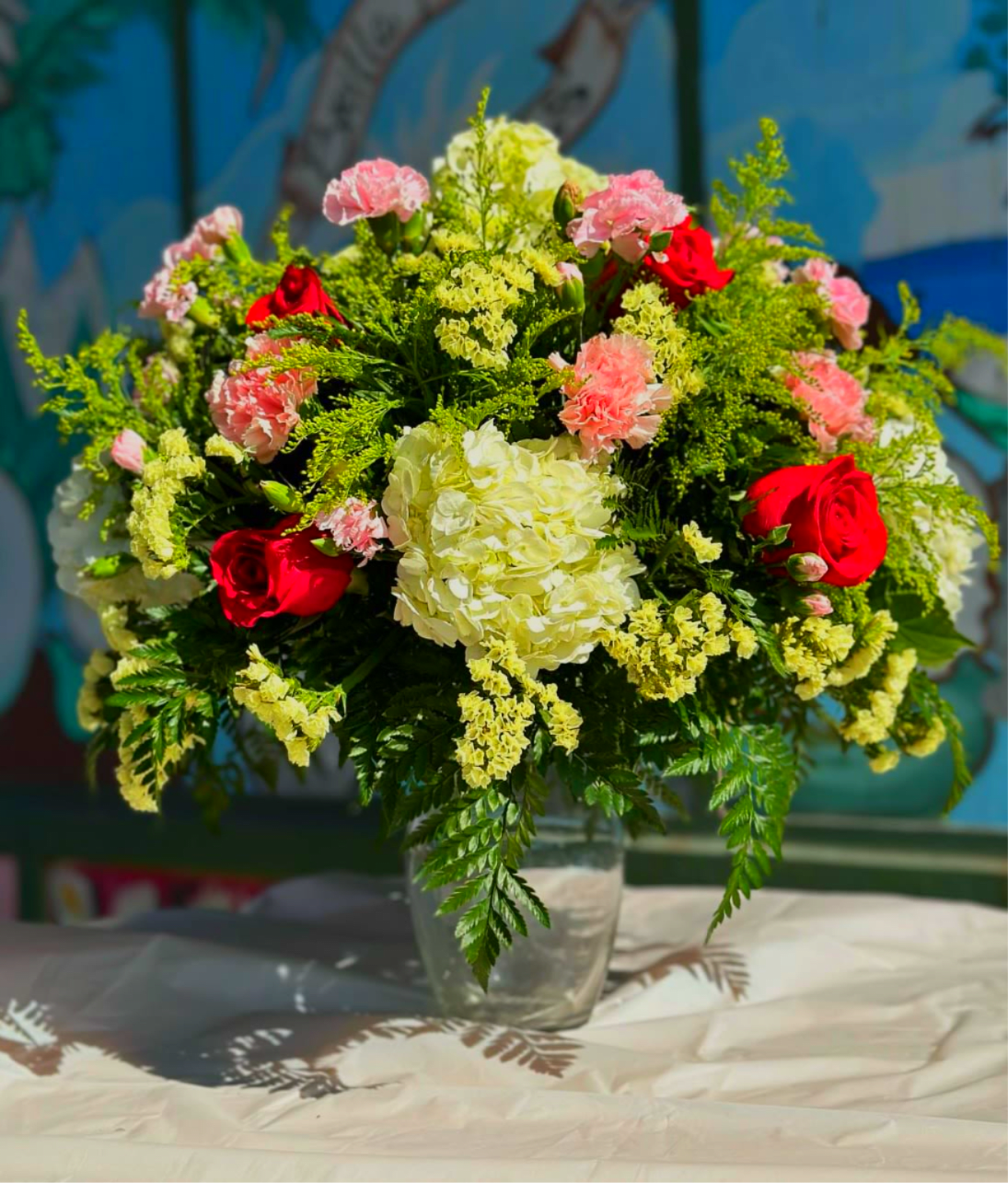  Centerpiece Red Rose and Pink Carnation - Perfect for a house warming gift. Arrangement is placed on a dish thats placed on a clear glass vase to give it an elevated look perfect for a table.