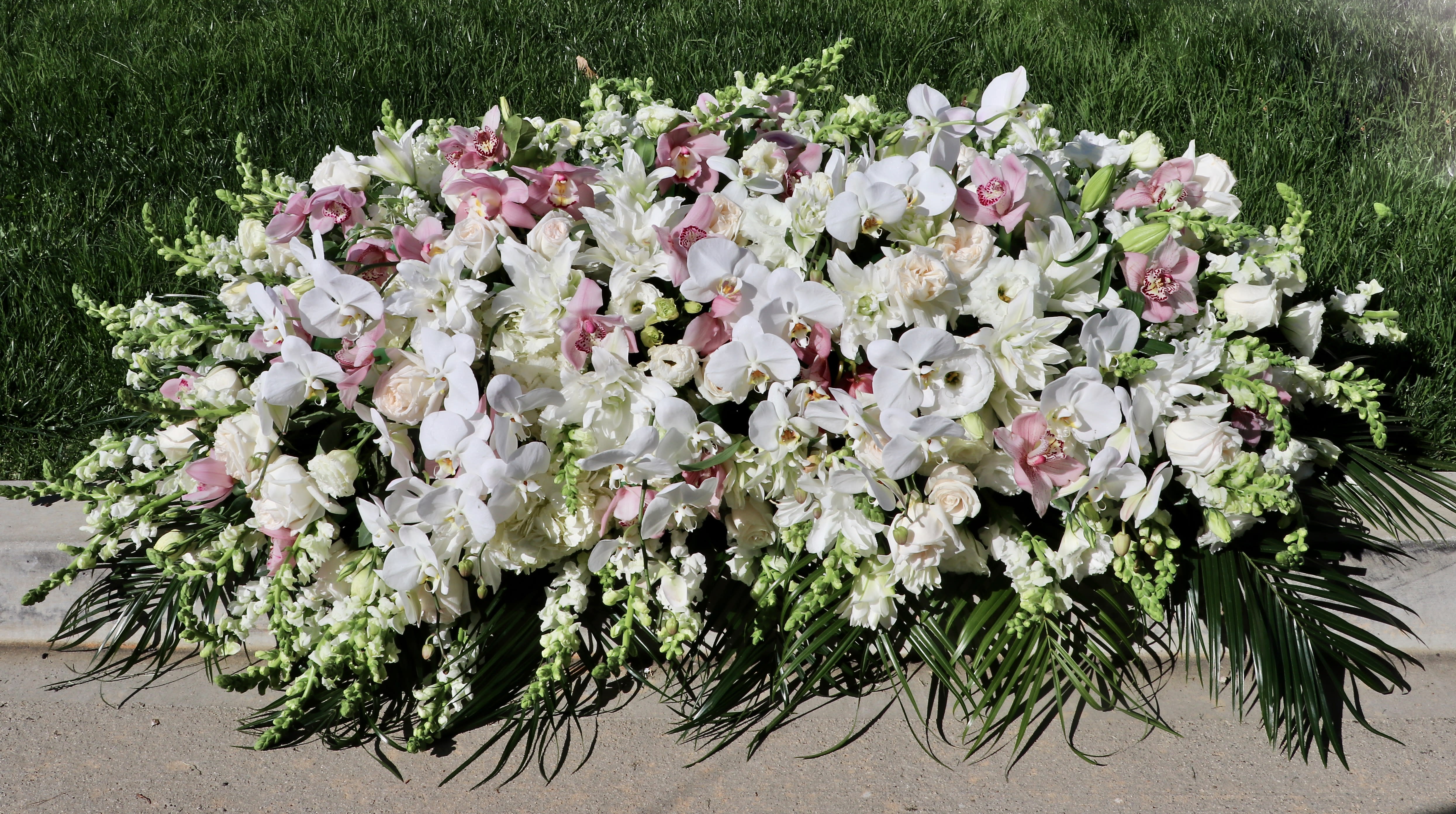 Rose and Orchid Casket  - This casket spray includes white orchids, roses, stargazer lilies, and hydrangeas.     Standard size is half casket, deluxe is 3/4 and premium is full casket.