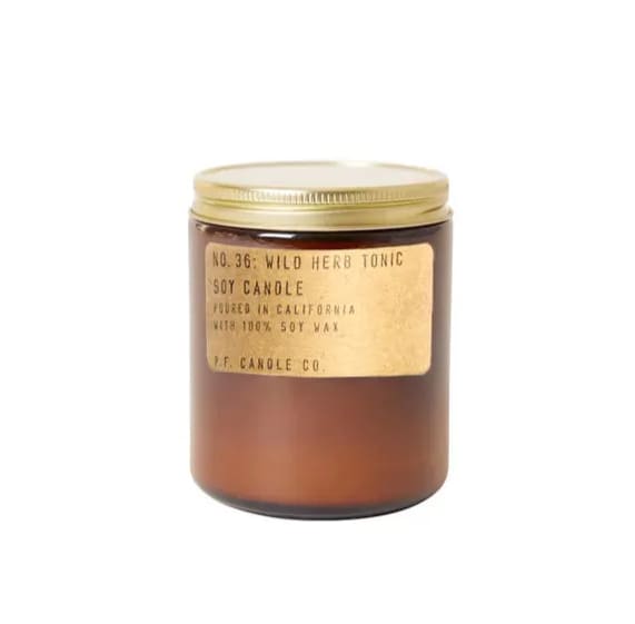 Amber jar candle with a gold lid and label