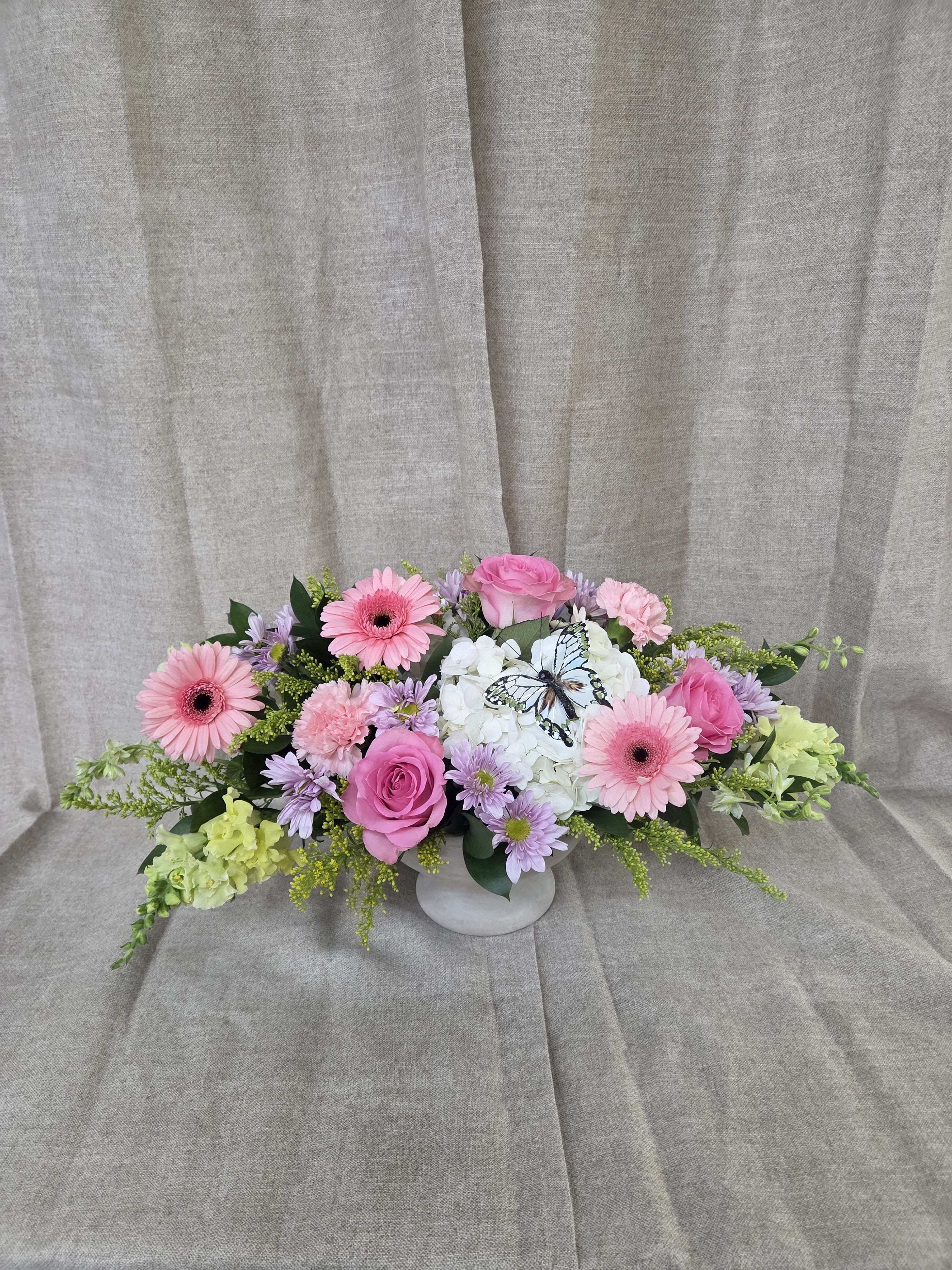 Butterfly Garden Bouquet - Graceful, fresh, and beautifully modern, our Butterfly Garden Bouquet captures the delicate beauty of a blooming garden in soft, elegant hues. Designed with a sophisticated blend of white, pink, green, and lavender blooms, this contemporary arrangement features clean lines, lush textures, and a light, airy feel that brings a touch of serenity to any space.
