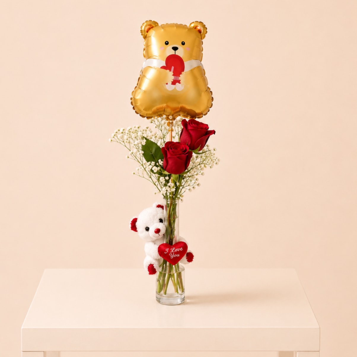 Bear Love (Designer Choice) - A romantic floral gift featuring fresh red roses, a soft plush teddy, and a cute teddy bear balloon, all beautifully arranged in a glass vase. The perfect way to say I love you!   Flower and roses and plush styles may vary based on availability, but the love-filled sentiment remains.    Perfect for: Anniversaries, Valentine’s Day, or just because!