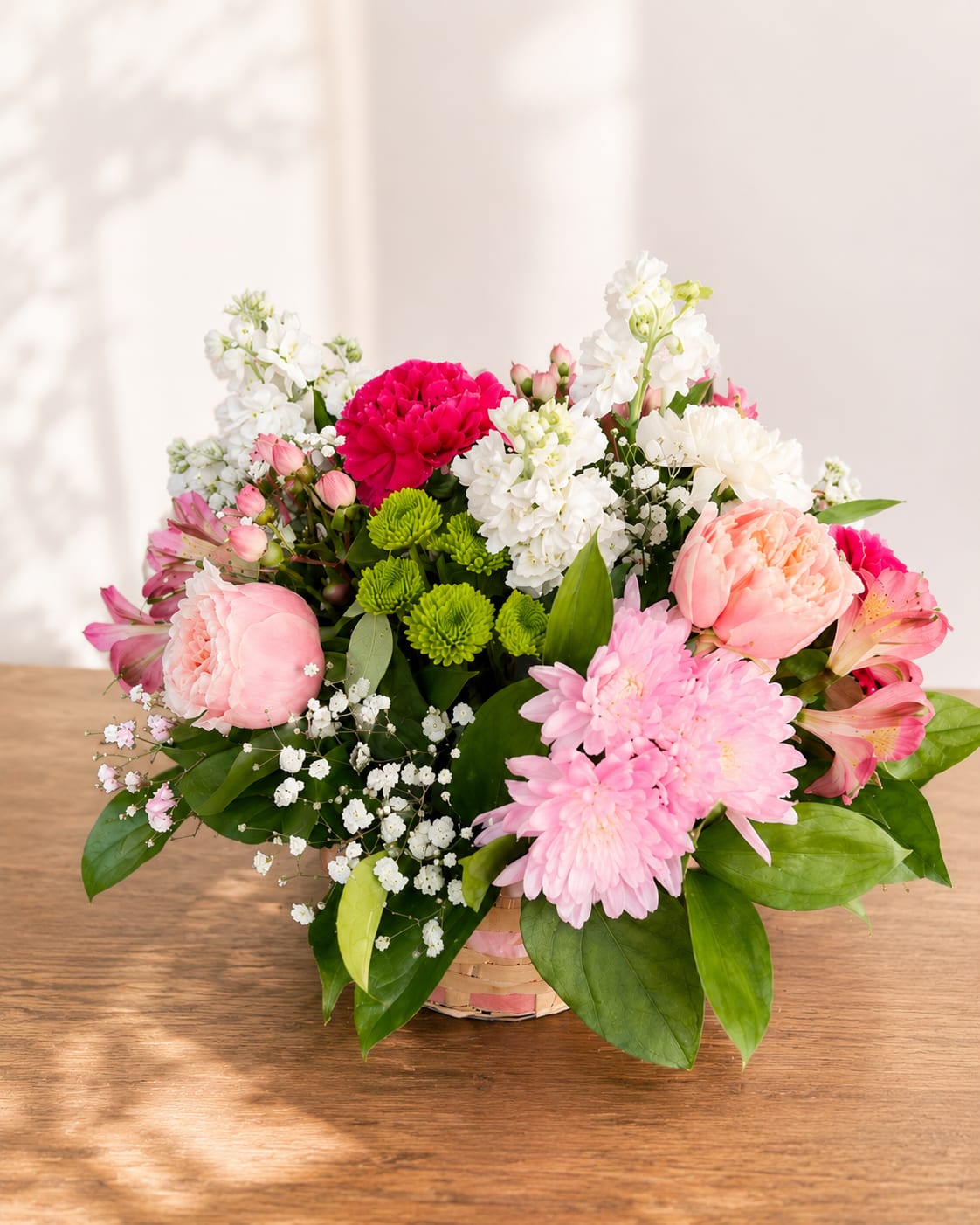 Pomona's Harvest – Designer's Choice Basket Arrangement - Inspired by Pomona, the Roman goddess of abundance and flourishing gardens, this Designer's Choice basket celebrates the beauty of each season through fresh, thoughtfully selected blooms.  Handcrafted in Flower Fairy's signature garden style, every basket is uniquely designed using the freshest premium flowers available. Our designers carefully select a beautiful seasonal mix of blooms, greenery, textures, and colors to create a full, naturally elegant arrangement with the charming presentation of a keepsake basket. While each design is one of a kind, every arrangement reflects the boutique quality and artistic style that define Flower Fairy.  Perfect for birthdays, anniversaries, thank-you gifts, congratulations, get well wishes, housewarmings, or simply brightening someone's day with fresh seasonal flowers.  Each arrangement is handcrafted by Flower Fairy using the freshest flowers available. Flower varieties and colors may vary based on seasonal availability, but we always preserve the overall style, fullness, and premium quality of every design.  Features: Designer's Choice basket arrangement Fresh seasonal flowers Garden-style floral design Keepsake basket Handcrafted by Flower Fairy Same-day flower delivery in Phoenix