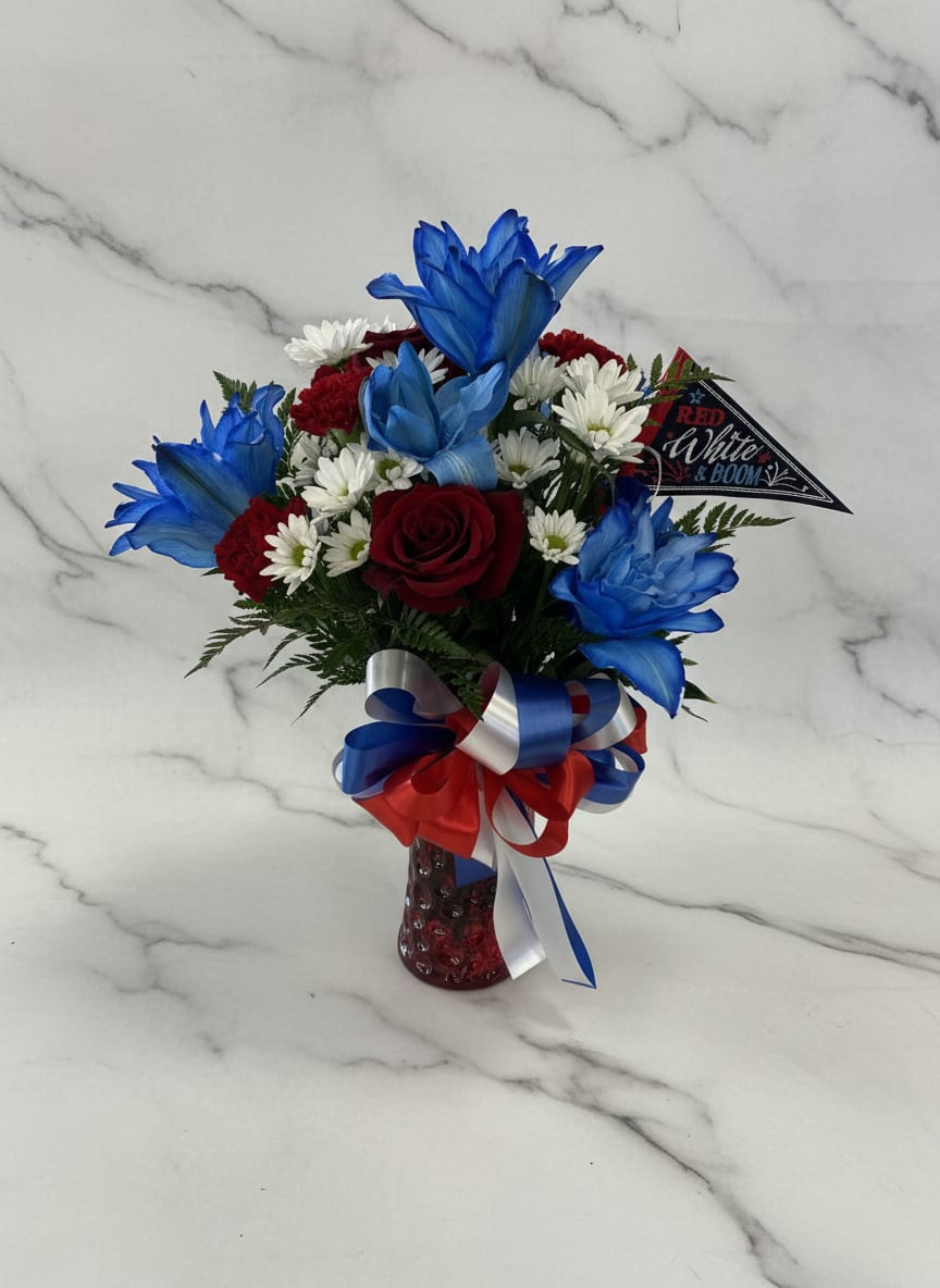 Red white &amp; Boom - A single red rose takes center stage in this Red, White &amp; Boom patriotic flower arrangement, perfect for Fourth of July or Memorial Day celebrations. The birthday-size of the bouquet and bold red, white and blue palette make it an ideal hostess gift or a thoughtful way to honor a veteran-she'll feel celebrated the moment it's set on the table. 