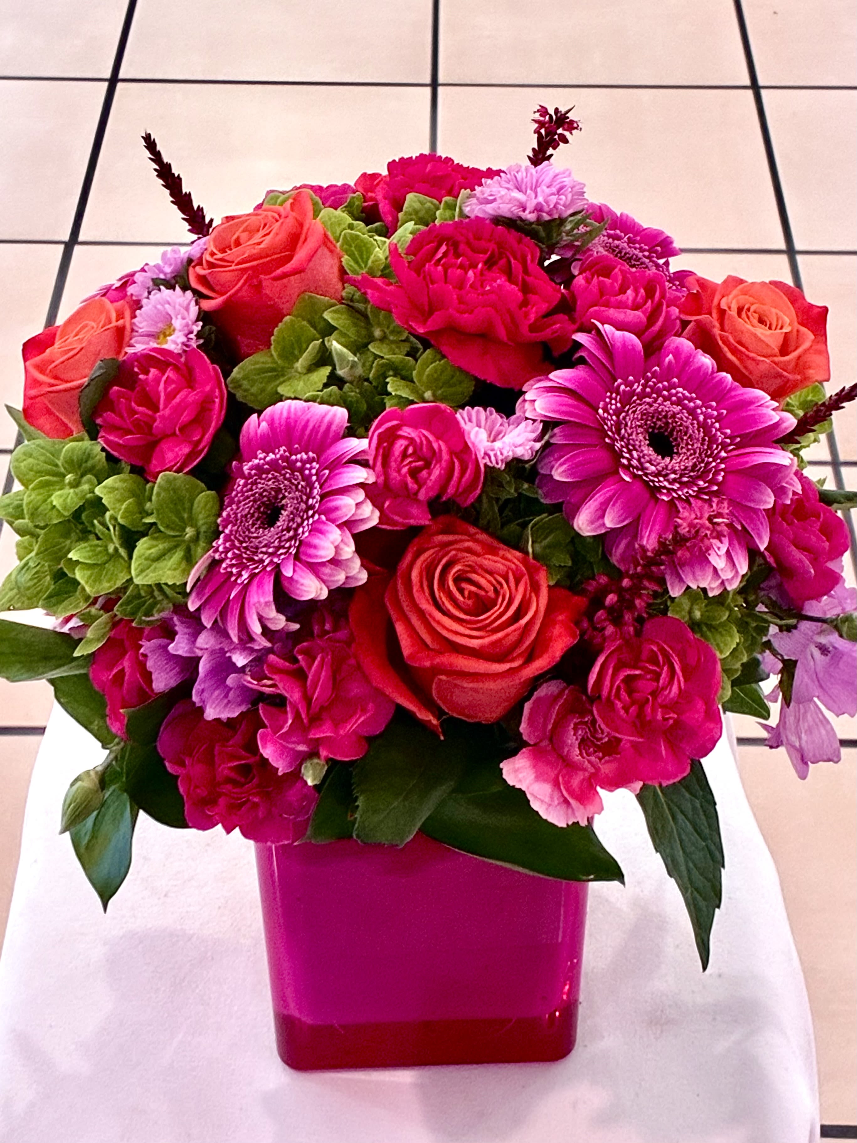 Hot Lady  - Hot Pink arrangement in a short cube vase. makes this arrangement look bright and beautiful, eye catching.  Good for all Occasion 