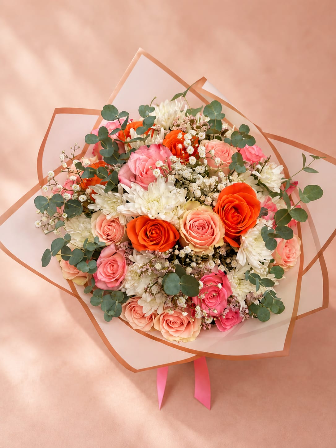 Zaria's Coral Bloom – Wrapped Bouquet - Inspired by Zaria, the Slavic goddess of the dawn and radiant new beginnings, Zaria's Coral Bloom celebrates the warmth and beauty of a summer sunrise. Premium coral and blush roses, crisp white chrysanthemums, fresh eucalyptus, and seasonal accent flowers are thoughtfully arranged and wrapped in elegant premium paper, creating a bouquet that feels both joyful and sophisticated.  Each bouquet is handcrafted by Flower Fairy using the freshest seasonal flowers available. Every design is naturally unique while preserving its signature lush garden style and harmonious color palette.  Perfect for birthdays, congratulations, thank-you gifts, Mother's Day, get well wishes, or simply brightening someone's day.  Features: Premium coral and blush roses White chrysanthemums Fresh eucalyptus Seasonal accent flowers Luxury wrapping Handcrafted by Flower Fairy Same-day flower delivery throughout the Phoenix Metro Area Designed by your local Phoenix florist