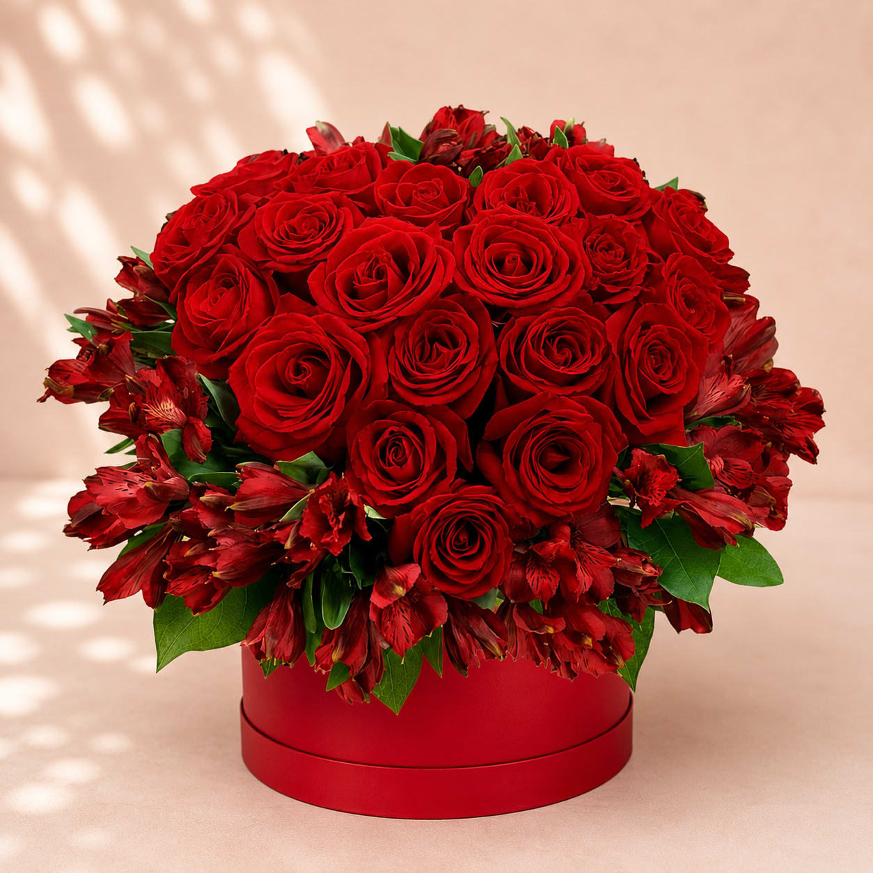 Carna's Endless Love – Luxury Rose Hat Box - Inspired by Carna, the Roman goddess of protection and enduring strength, Carna's Endless Love is a breathtaking expression of romance and lasting devotion. Premium red roses are beautifully framed with vibrant red alstroemeria and lush greenery, creating a rich monochromatic design that feels both elegant and unforgettable.  Arranged in Flower Fairy's signature keepsake hat box, this luxurious floral gift is handcrafted using the freshest flowers available. Its classic red palette makes it the perfect choice for anniversaries, Valentine's Day, romantic celebrations, proposals, or simply expressing love without words.  Each arrangement is individually handcrafted, making every design naturally unique while preserving its signature luxurious style.  Features: Premium red roses Red alstroemeria Fresh seasonal greenery Luxury keepsake hat box Handcrafted by Flower Fairy Same-day flower delivery throughout the Phoenix Metro Area Designed by your local Phoenix florist