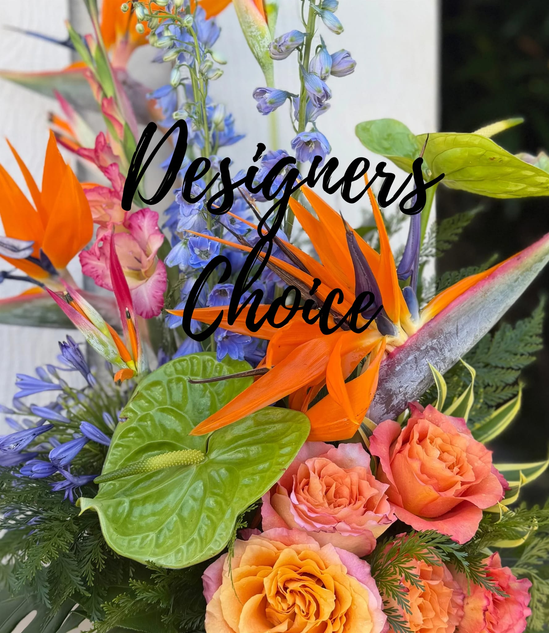 Tropical bouquet with orange birds of paradise and peach roses