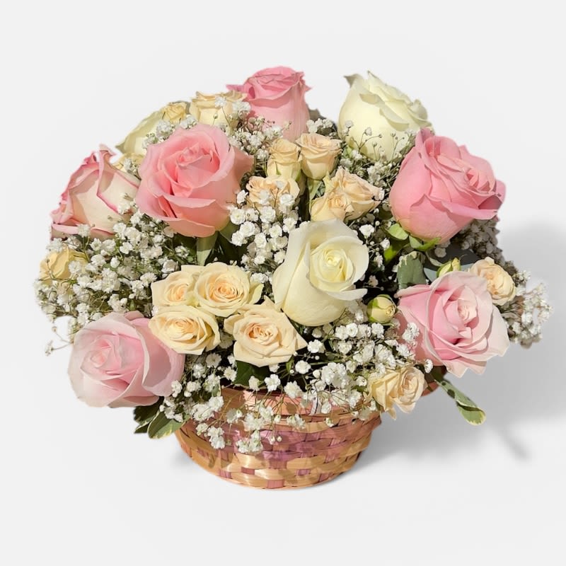 Rosy Little Love Nest  - Delicate, sweet, and full of charm, our Rosy Little Love Nest is a soft spring arrangement designed to feel like a warm hug in flower form. Featuring a beautiful blend of blush pink and creamy ivory roses, accented with petite spray roses and airy baby’s breath, this basket creates a lush, cloud-like texture with a romantic garden feel.  Carefully arranged in a woven basket, the blooms form a full, rounded shape that looks effortlessly elegant while still feeling light and playful. The gentle pastel tones make it perfect for Easter, birthdays, or sending a thoughtful “thinking of you” message.  Handcrafted with fresh, premium flowers, this arrangement is ideal for tabletops, gifting, or adding a soft, romantic touch to any space.   Perfect for: Easter, spring gifting, birthdays, and sweet everyday moments  Includes roses, spray roses, baby’s breath, and seasonal greenery  Designed fresh and ready to enjoy  Flower shades may vary slightly based on availability  A cozy little nest of roses made to brighten hearts and spaces alike 