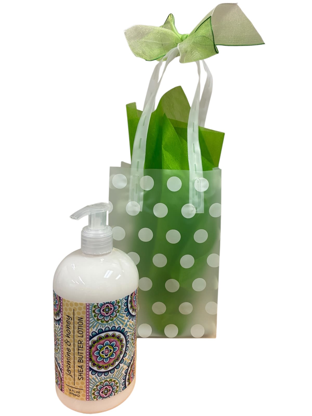Jasmine &amp; Honey Lotion - A fresh, cheery gift that feels like a mini spa moment- presentation features a Jasmine &amp; Honey lotion bottle tucked into a translucent green polka-dot gift bag, perfect as a birthday, thank you, housewarming, or "just because" gift. The presentation reads like a small, thoughtful token that will make the person you're thinking of feel pampered and appreciated without being over the top.  The set includes a white pump bottle of jasmine and honey shea butter lotion displayed against bright green tissue paper, soft white accents, and a pale green ribbon bow tied to the bag's handles. Packaged in a reusable gift bag with coordinating ribbon and tissue, it arrives ready to give and adds a lift of scent and color to the recipient's day.