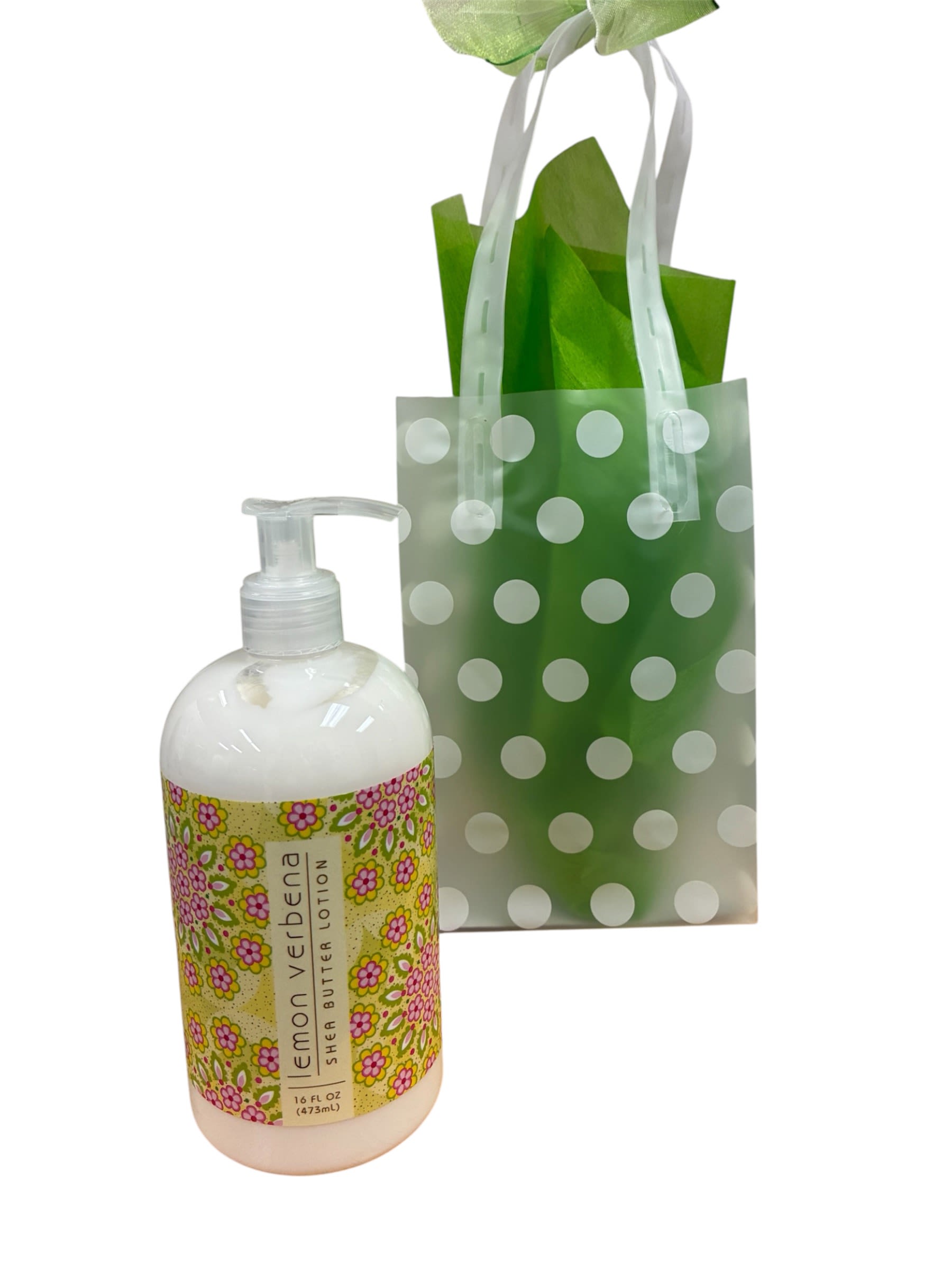 Lemon Verbena Lotion - A bright Lemon Verbena lotion gift makes a cheerful little present for birthdays, thank-yous, or just-because moments-the kind of self-care pick that makes the person you're thinking of feel refreshed and cared for. This gift set reads like a springtime treat: the product is a large pump bottle of Lemon Verbena shea butter lotion presented as a casual gift or spa-style indulgence.  The lotion's floral-patterned label mixes pink, yellow, and green tones for a feminine, sunny look; it comes nestled in a translucent green gift bag patterned with white polka dots and finished with ribbon handles for easy carrying. The combination of fresh green, soft white accents, and touches of pink and yellow gives the set a light, uplifting visual that feels both personal and polished.  Perfect for a coworker, neighbor, or friend who deserves a small pampering moment, this set is ready to gift as shown-no extra wrapping required. Its compact, gift-bag presentation makes it easy to drop into a delivery or bring along to a casual celebration; the pump bottle and bag keep the lotion practical for everyday use and display.