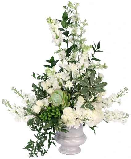 Soothing Comfort Funeral Flowers - Elegant and pristine, this sympathy arrangement embodies the life of a lost loved one. Soothing Comfort expresses compassion with its white florals of stock, snapdragons, daisy poms, and larkspur, encompassed by greens and succulents. Offer your condolences with this classically stunning display.  Includes: White Hydrangea, Green Hypericum, White Larkspur, White Daisy Poms, White Snapdragons, White Spray Roses, White Stock, Greens: Variegated Pittosporum, Italian Ruscus, Israeli Ruscus, Succulent, White Urn.