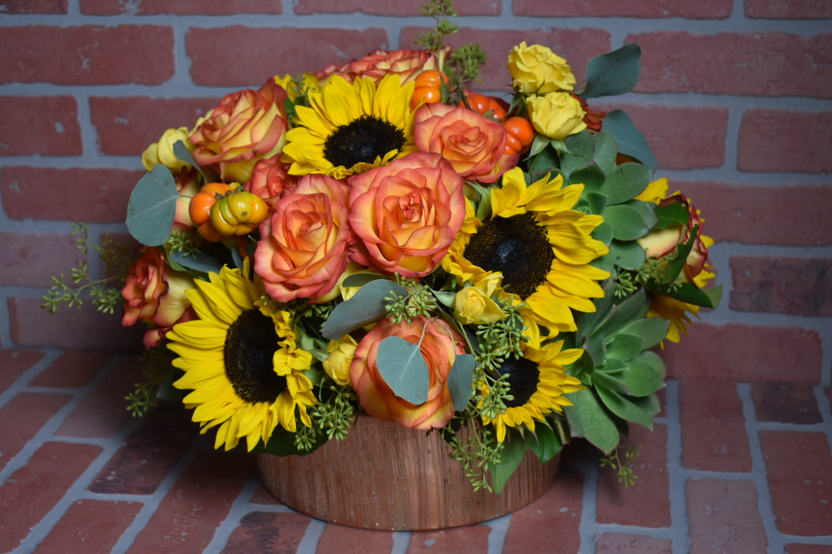 Magic Bouquet  - Fresh cut orange roses with sunflowers and cactus in a lovely round gold vase 