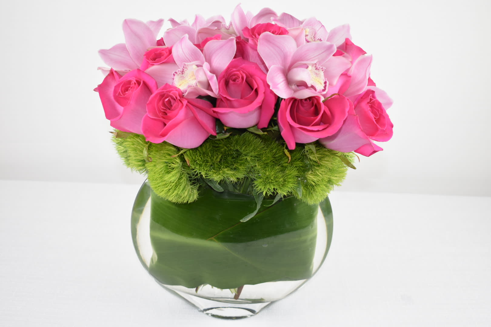 Pink Roses  - Unique glass vase well arranged with Hot pink Ecuadorian roses and pink cymbidium orchids  The Perfect Gift for any occasion 