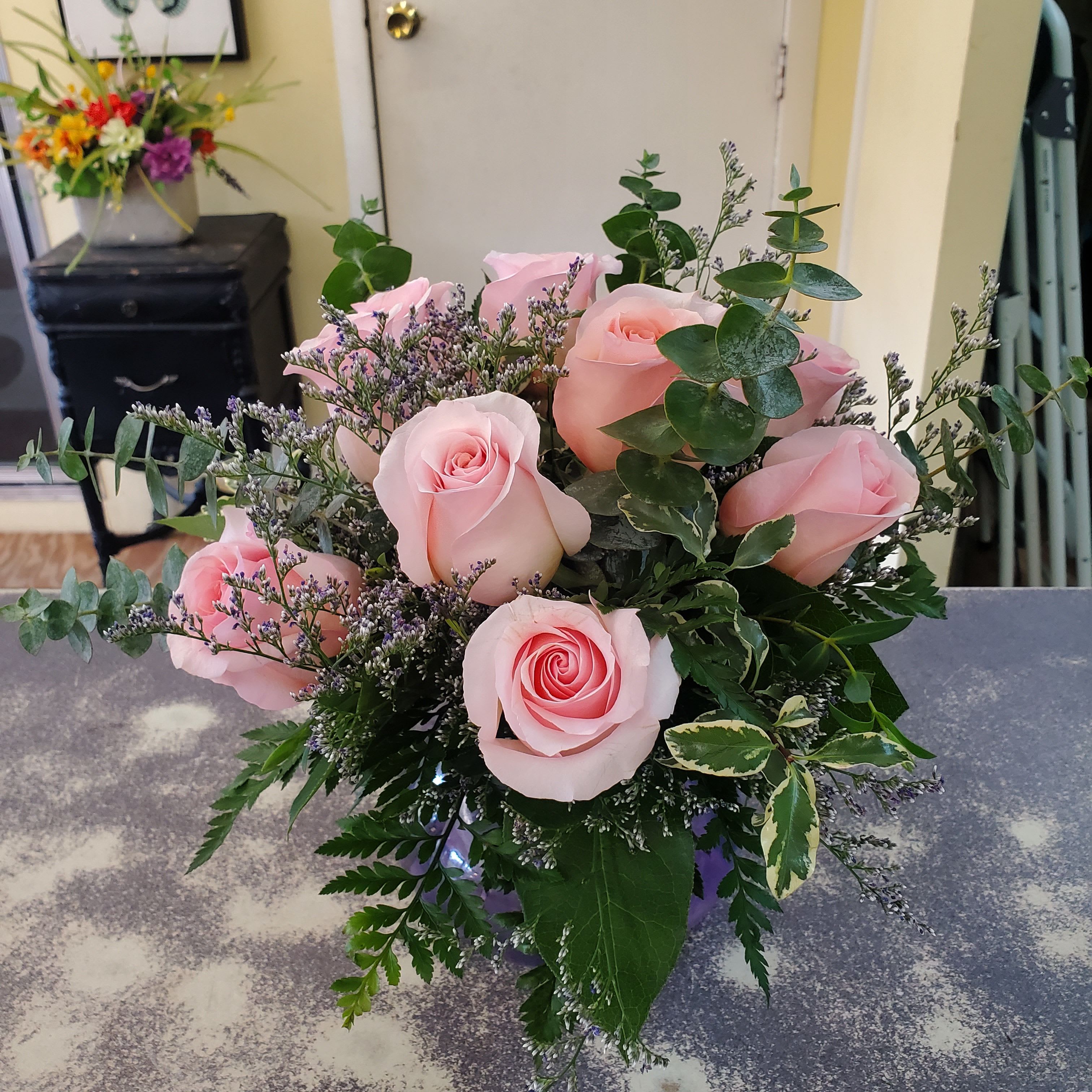  Rose Bunch Bouquet { Pink} - A compact glass vase filled with 7 - 8 color roses,  a variety of greens and fill.  **COLORS WILL VARY DEPENDING ON THE AVAILABILITY OF THE DAY **
