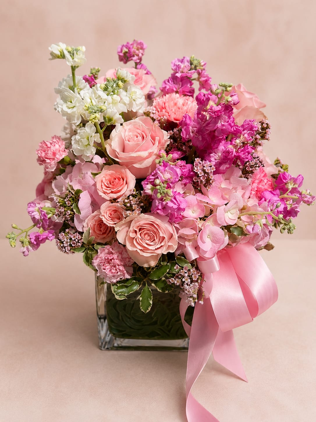 Designer's Choice Vase - Trust our designers to create something truly beautiful. Designer's Choice Vase is handcrafted using the freshest premium seasonal flowers available, allowing our florists to create a unique arrangement inspired by the colors and blooms of the season.  Designed in Flower Fairy's signature Garden Embrace™ style, each arrangement features a lush, rounded composition with elegant textures and harmonious color combinations. While flower varieties and colors change throughout the year, every design is created with the same attention to detail, balance, and luxurious presentation.  Whether you're celebrating a birthday, anniversary, welcoming a new baby, expressing gratitude, or simply brightening someone's day, our Designer's Choice Vase is a timeless gift that lets our creativity shine.  Flower Fairy Signature Style Garden Embrace™ — A lush, rounded garden-inspired composition that highlights seasonal blooms with timeless elegance and abundant texture.  Features: Flower Fairy Signature Style: Garden Embrace™ Designer's premium seasonal flower selection Classic rounded arrangement Elegant glass vase Handcrafted by Flower Fairy Same-day delivery throughout the Phoenix Metro Area