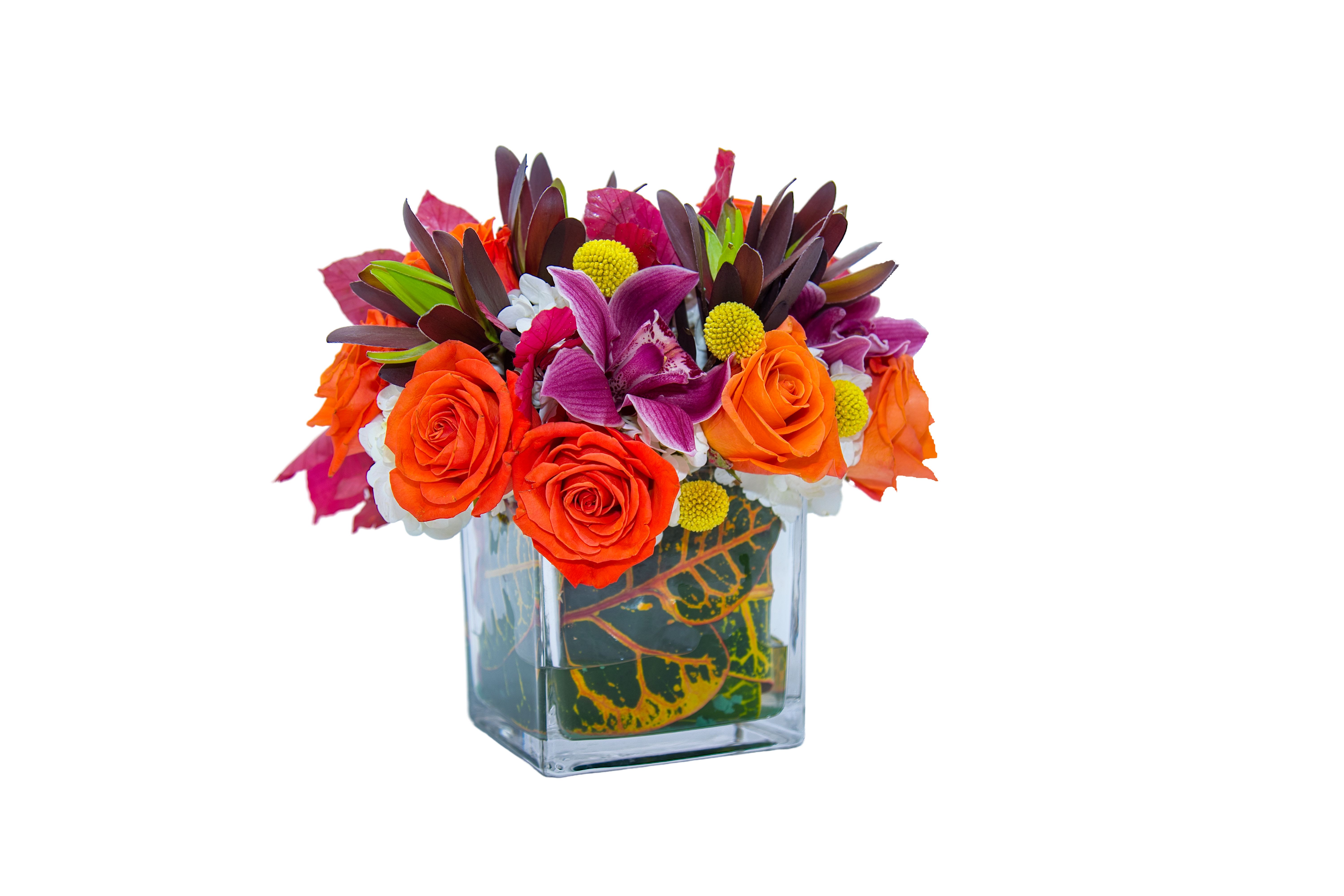 Bright bouquet of orange roses and purple flowers in a glass vase