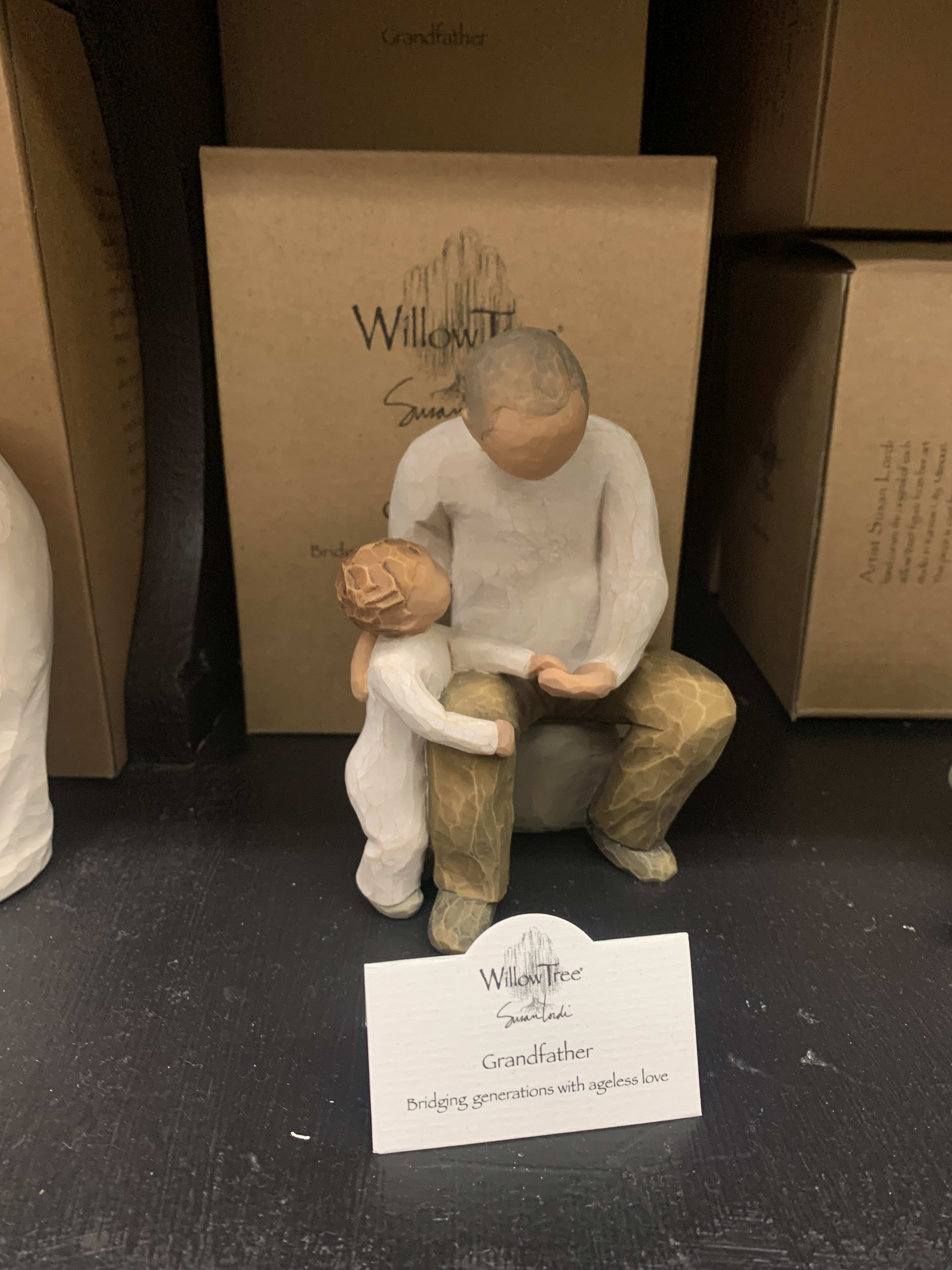 Wooden grandfather and child figurine on a shelf