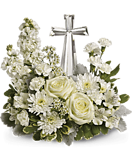 White floral arrangement with a silver cross centerpiece
