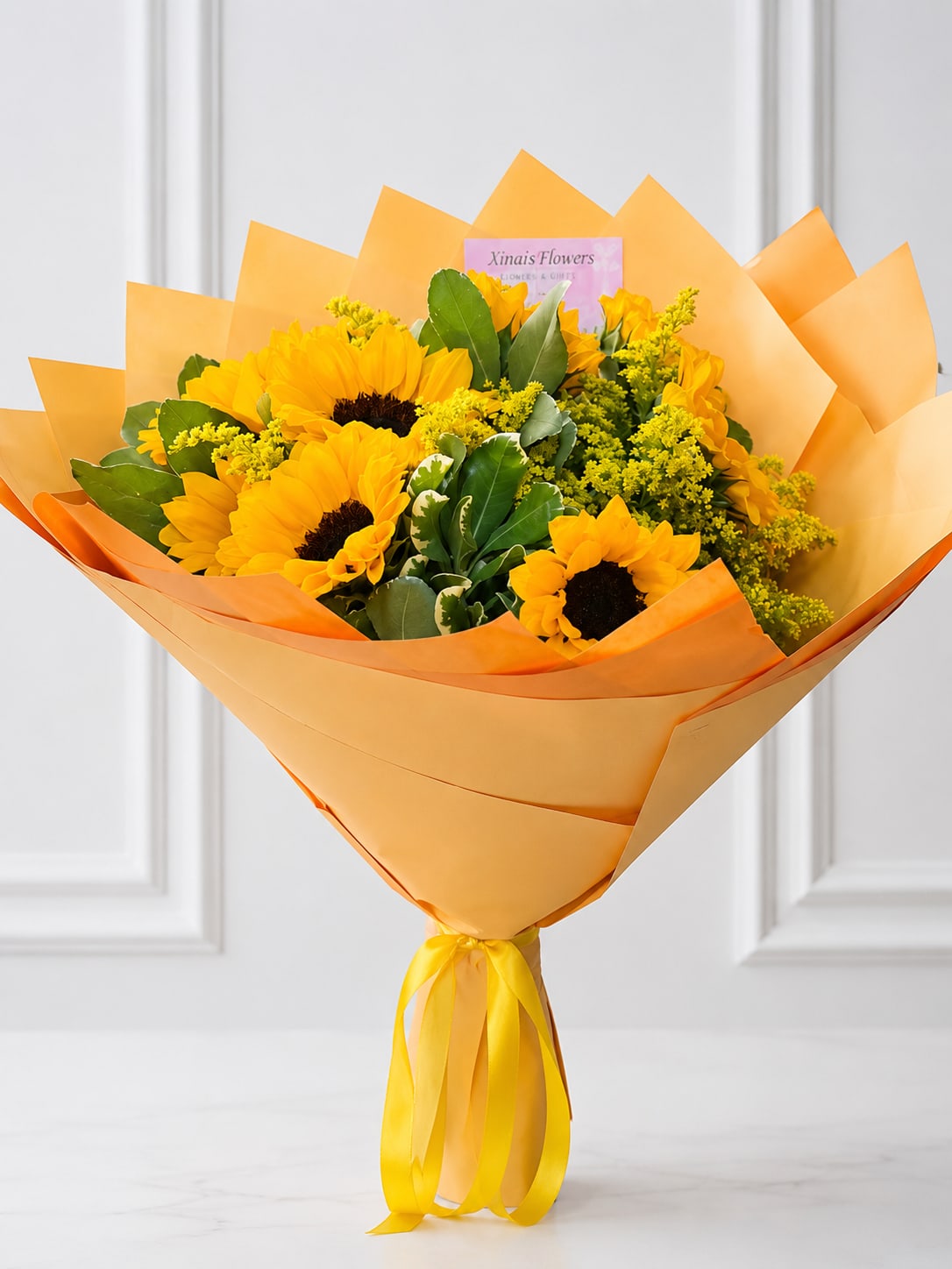 Golden bouquet  - bright and elegant hand-tied bouquet featuring radiant sunflowers, golden solidago, lush premium greenery, and luxury wrapping finished with a satin yellow ribbon. This cheerful arrangement is perfect for birthdays, congratulations, thank-you gifts, housewarmings, or to brighten someone's day.