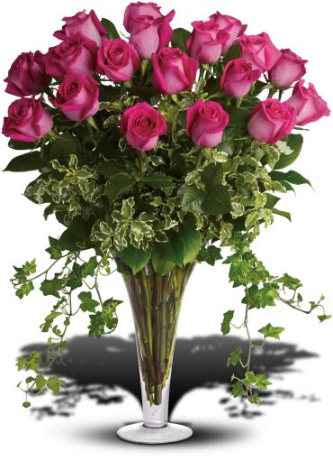 Pink roses in a tall glass vase with trailing ivy