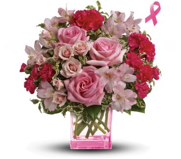 Pink roses and carnations in a pink glass vase with a ribbon symbol