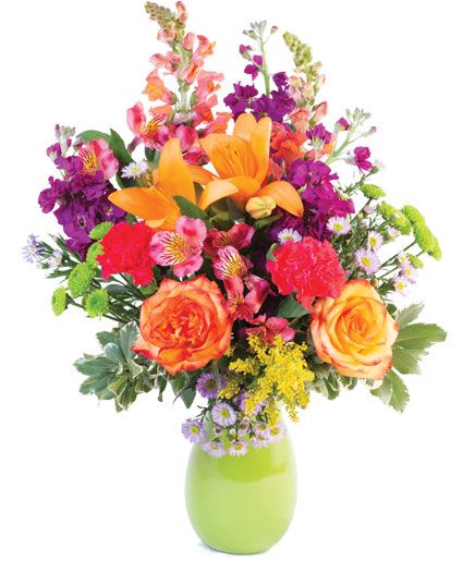 Wild Variety Flower Arrangement - Captivating and alluring, this bouquet is a winner! Featuring gorgeous orange lilies, lovely roses, beautiful purple asters, charming hot pink carnations, and more, Wild Variety is a lively and energetic mix. You can't go wrong sending this vibrant flower bunch!  Includes: Green Plastic Vase, Greens: Variegated Pittosporum, Salal, Flowers: Purple Stock, Purple Monte Casino Asters, Hot Pink Alstroemeria, Orange Snapdragons, Hot Pink Carnations, Green Button Poms, Yelloworange Bicolor Roses, Orange Lilies, Solidago.