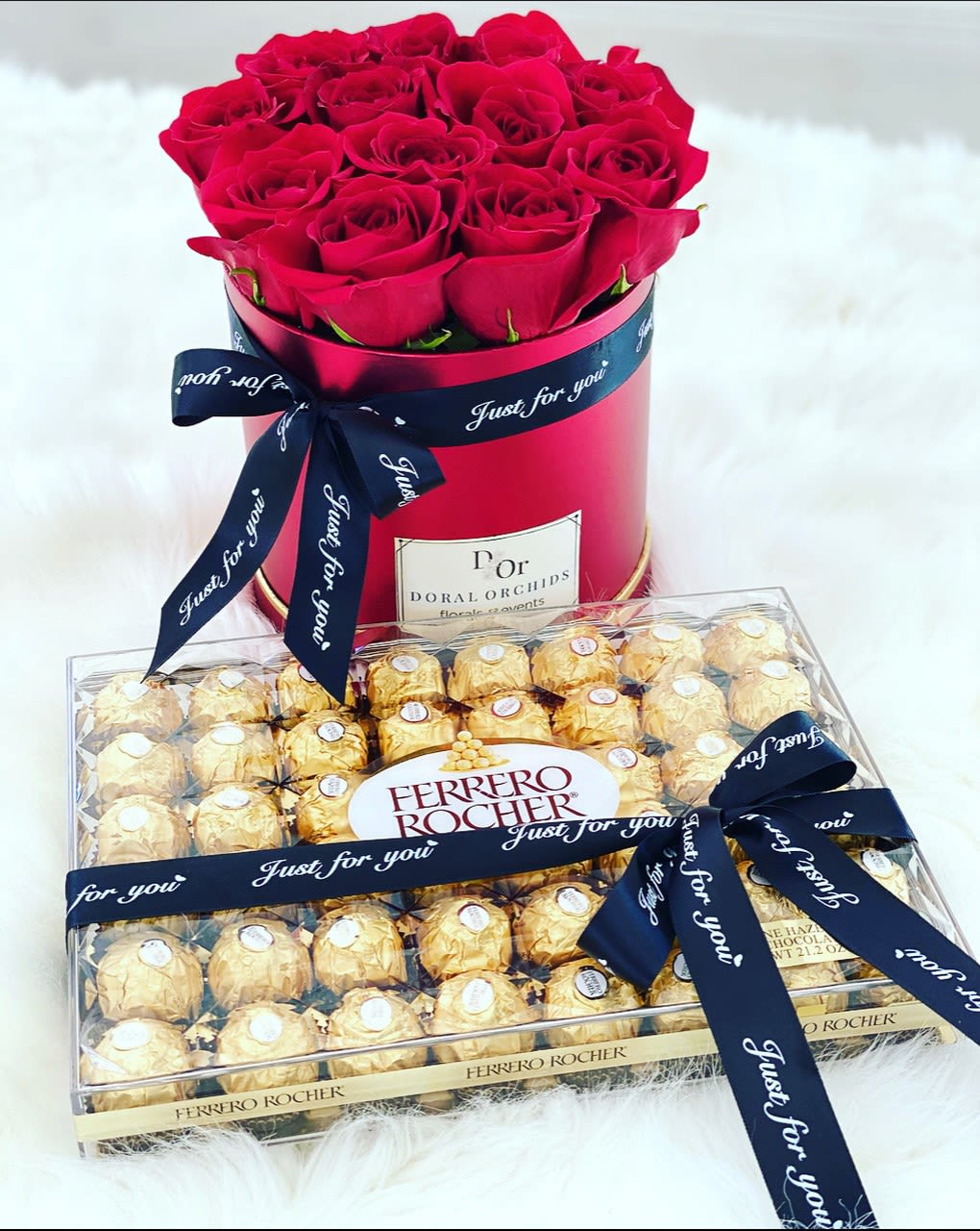 Red roses in a round box with a box of Ferrero Rocher chocolates