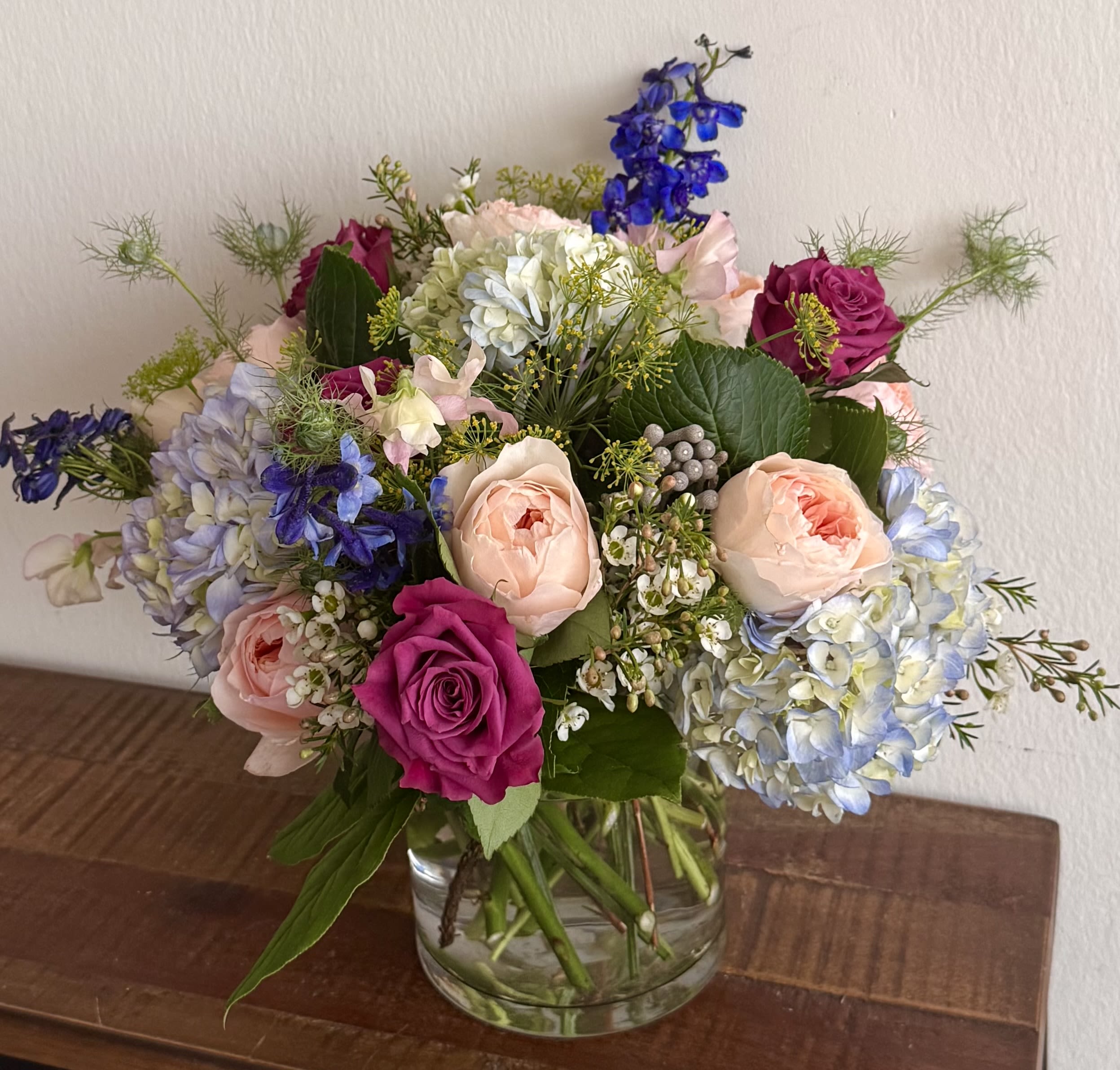 Garden Rose &amp; Blue Hydrangea Bouquet  - Soft, romantic, and garden-inspired, our Blushing Garden Rose Bouquet features fragrant garden roses, blue hydrangeas, premium roses, delphinium, sweet peas, waxflower, and seasonal accents in a clear glass vase. Handcrafted with fresh blooms, this elegant arrangement is perfect for birthdays, anniversaries, sympathy, thank-you gifts, or everyday celebrations. Available for flower delivery throughout Washington, DC.