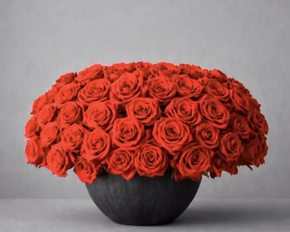 Rouge Royale - Rouge Royale is the ultimate expression of luxury, passion, and timeless elegance. This spectacular arrangement features approximately 75 premium red roses, meticulously hand-designed in a sophisticated black designer bowl, creating a full, perfectly rounded silhouette that radiates refinement from every angle.  Crafted for life's most meaningful moments, Rouge Royale is an unforgettable gift for anniversaries, proposals, birthdays, Valentine's Day, or any occasion worthy of an extraordinary floral statement.  Every arrangement is handcrafted by the designers at The Embassy of Flowers using only premium fresh roses to ensure exceptional beauty, elegance, and lasting impression.  Includes:  Approximately 75 premium red roses Elegant black designer bowl Professional floral design for maximum freshness Complimentary personalized message card